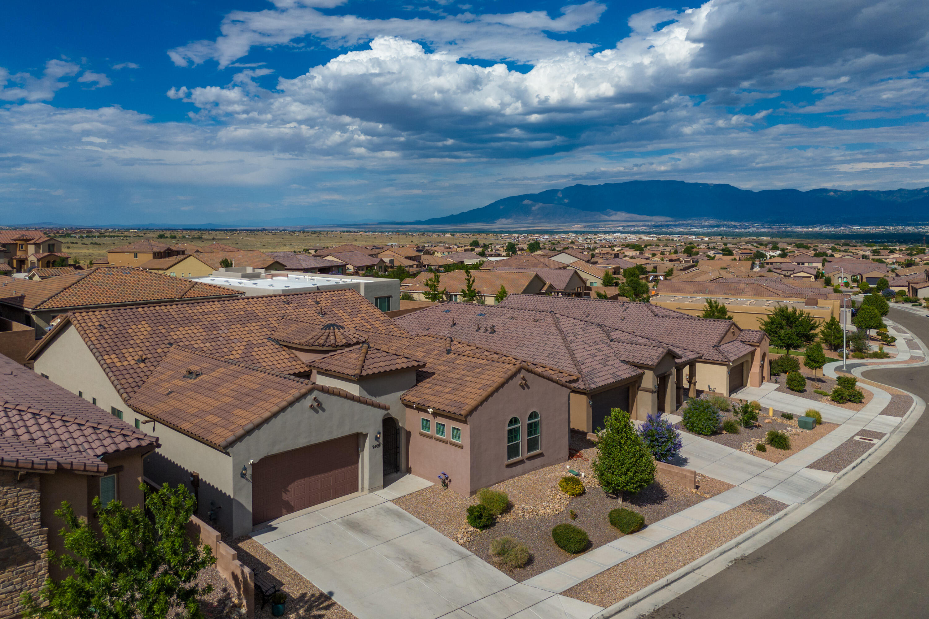 Discover the luxurious comfort of the SINGLE-STORY Patagonia floor plan by Pulte Homes, construction finalized in 2019. Nestled in the sought-after Montecito Vistas neighborhood, 9109 Vista Dibujo offers abundant, multi-generational living space ALL ON ONE LEVEL. The heart of the home is a spacious, centralized kitchen and gathering room designed for effortless entertaining. Chef's kitchen with rich granite countertops, maple cabinetry, stainless appliances, large island, pantry, and breakfast nook. *Versatile guest living space with en suite bath, ideal for a multi-generational lifestyle.* Make memories in your formal dining area, and embrace outdoor living on your covered patio with breathtaking views of the Sandias and cityscape. Refrigerated/central air for year-round comfort. No PID!