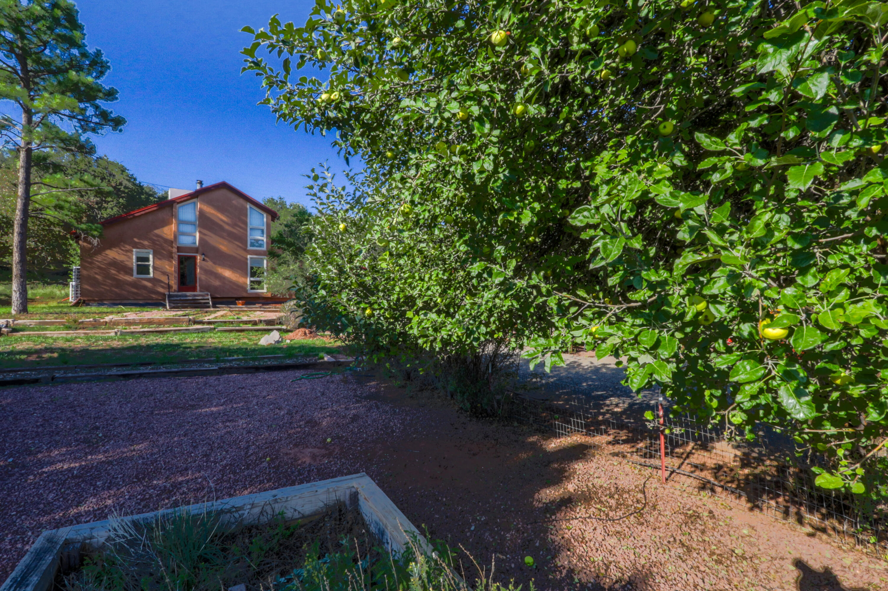 Step into tranquility in this Sandia Knolls beauty. Situated on a .96ac lot, this 5 bed, 3 full bath home enjoys fruit trees, raised garden beds, an oversized 6 car metal garage with workshop, wood stove, basement, large deck, root cellar, and more. Enjoy quiet mountainside living with all of the conveniences of Albuquerque close-by. Only minutes from ski slopes, hiking, mountain-biking, and local eateries. Owned Solar. 8,000 gallons of Rain-water storage via seamless gutters.