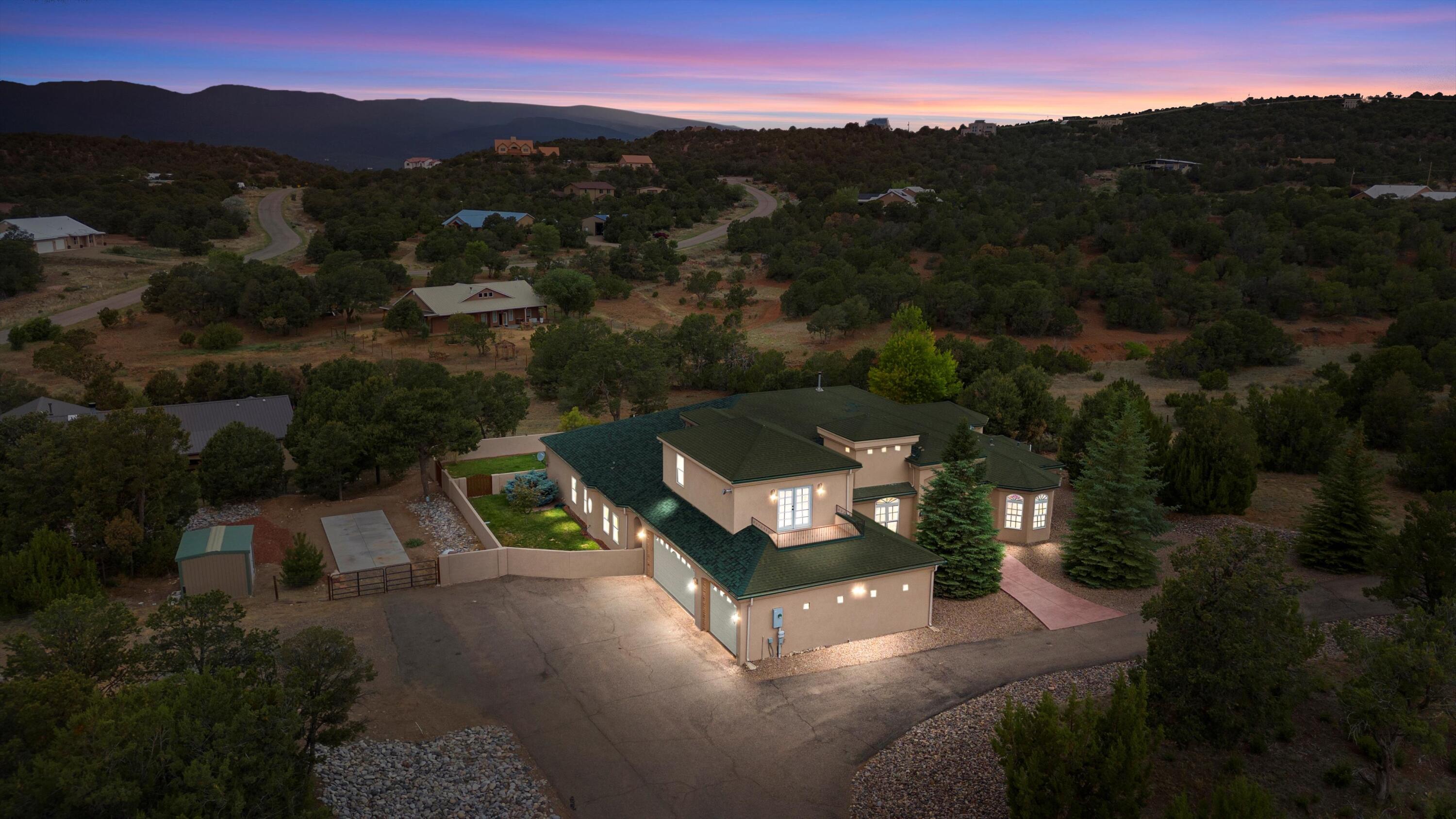 Sandia Park Oasis Awaits! This expansive 6 bed, 4 bath home offers the perfect blend of indoor & outdoor living providing ample space for entertaining andcomfortable living with luxury features! Inside, you're greeted by soaring cathedral ceilings that create an open, airy atmosphere. The gourmet kitchen boasts granitecountertops, custom cabinets, and stainless appliances. The primary suite presents his and her closets and a rejuvenating sauna. Upstairs, find a versatile media room ideal for movie nights. Step outside to your private paradise: a sparkling inground pool, relaxing hot tub, and a fire pit for cozy evenings under the stars. Need storage? This home hasyou covered with an RV pad with hookups, a storage shed, and a 3-car garage. This home has it all! Don't miss out!