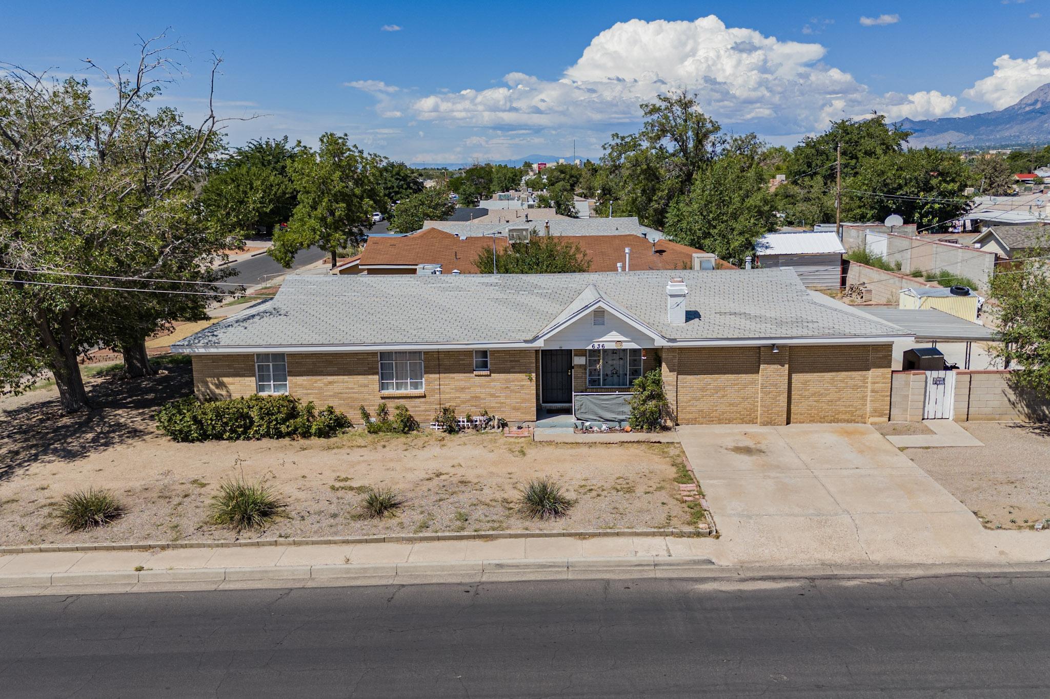 Come and see this Lovely brick home in East Albuquerque. This charming home offers 3 spacious bedrooms with a large 20X18 bonus area that can be utilized as a 4th bedroom, a family room, a home-based business, or a hobby room. This area includes a large closet, a gas fireplace and a separate entrance if needed. The property has been well maintained recent updates include a front door and interior doors, no carpet, updates to the bathrooms include new toilets, shower door and vanities. Kitchen has updated backsplash, counters, and painted cabinets. The dining room is perfect for entertaining, and the spacious laundry room provides ample storage space. 2 coolers help keep the home cool in the summer season. Situated on a huge corner lot, this home also features possible