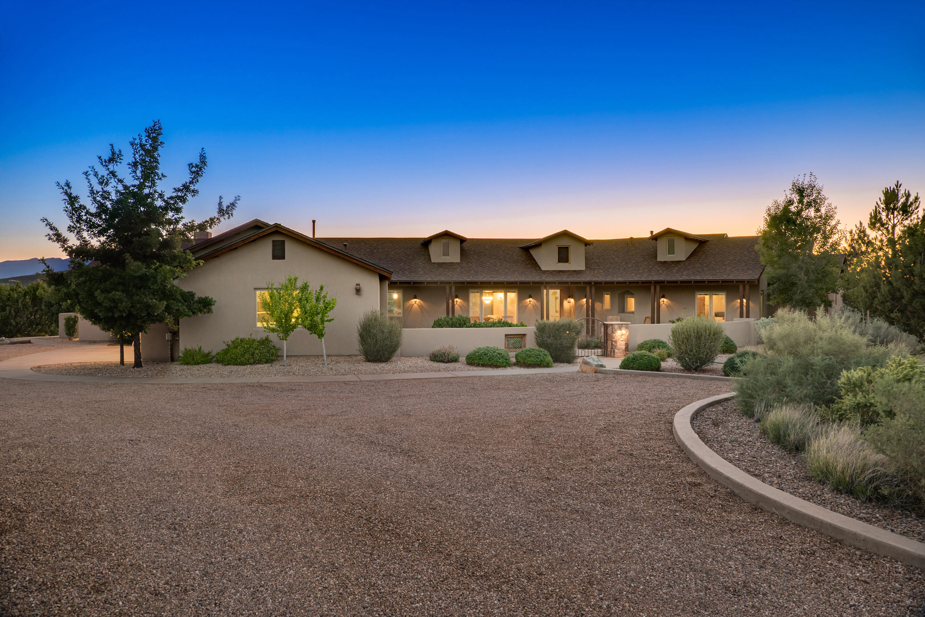 A stunning single-level home on a premium lot, with 700 acres of open space and breathtaking red rock canyon and mountain views. Open floor plan features 4/5 bedrooms, 3.5 baths, & split layout with two private guest wings. Gourmet kitchen, integrated with the great room, includes granite countertops, a prep sink, stainless steel appliances, an island, bar, & breakfast nook. Primary suite offers a serene sitting area, walk-in shower, & large walk-in closet. Multiple covered outdoor areas embrace the natural surroundings. One bedroom outfitted with shelves & desk, perfect for home office. Manned gated community, pool and spa. Just 20 minutes from Albuquerque and 45 minutes from Santa Fe, with nearby dining, golf, skiing, and hiking-- a perfect balance of seclusion, security, & convenience.