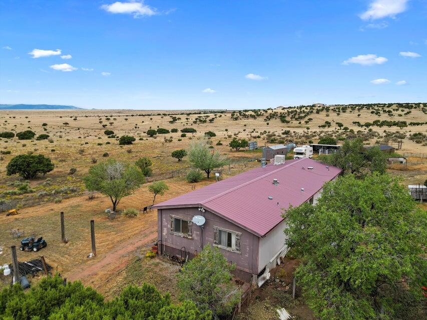Surrounded by the stunning natural beauty this property offers a peaceful and serene environment. With 160 acres at your disposal, you'll have the freedom to enjoy outdoor activities, cultivate gardens, or simply soak in the tranquility of the countryside. It is ready for your horses with a corral and round pen! The potential for creating a unique and personalized living space is immense. With a little TLC this home will truly shine! There is a 5,000 gallon water holding tank, pro panel roof, detached garage, and more!   Embrace the opportunity to make this 160-acres your own, and unlock the full potential of this remarkable piece of rural paradise.