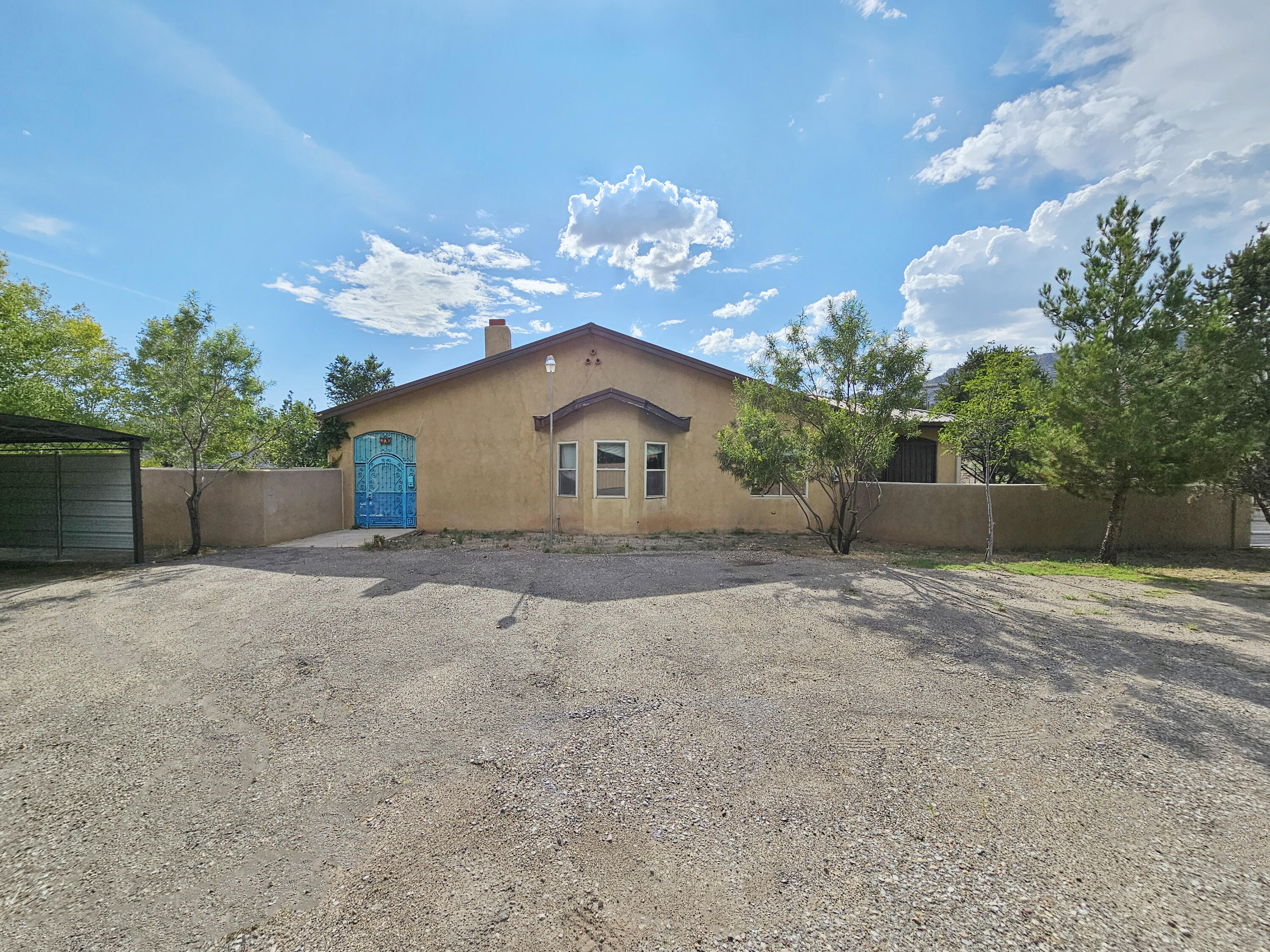 Come take a look at this fantastic home! This home is situated on a sprawling 1.3 acre lot just outside the city. Enjoy the peace and tranquility of rural living while still being close to all the amenities of Albuquerque. The home features a spacious living area with a cozy fireplace, formal dining area, a large kitchen with plenty of counter and storage space. There is a large primary bedroom on the main side of the home and an in-law quarters on the opposite side that also has its own kitchen, living area, bedroom and bathroom. The yard is perfect for entertaining with plenty of room to roam and play. This is the perfect home for those looking for country living while still having access to the city amenities. Come take a look!