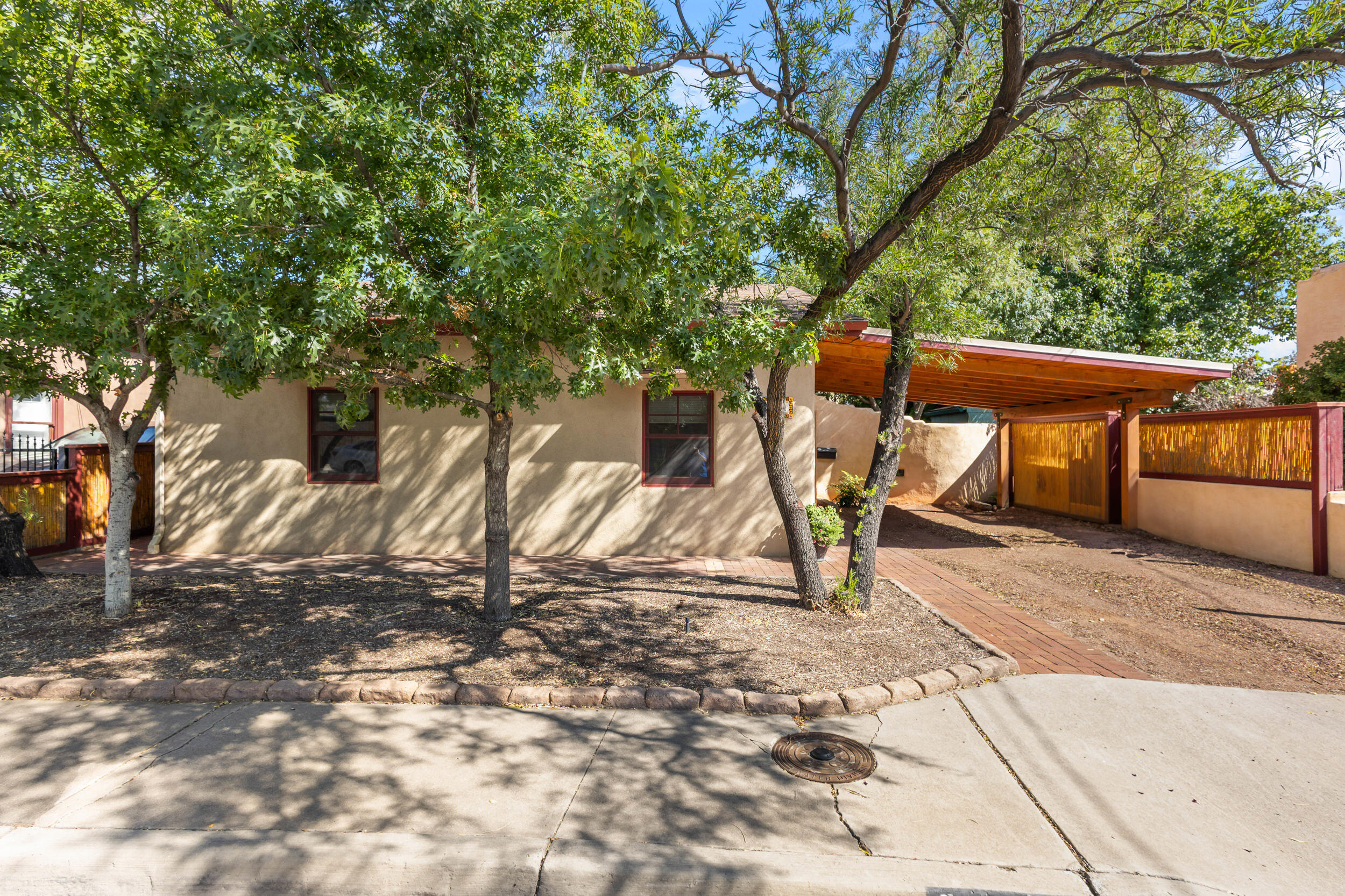 Exquisite 2 bedroom, 2 bath,  possible 3 bd/FLEX room,  Adobe home with contemporary presentation, nestled along the Mountain Road corridor of Downtown/Old Town Albuquerque.  Lovingly, completely restored in 2008. American Clay walls, Viga Ceilings, solid wood doors, Pella Windows, reclaimed Douglas Fir window sills and doorways, tile, cork flooring and wool carpet.  Custom Alder cabinetry throughout with granite counters and butcher block in kitchen, Hunter Douglas Blinds  Lots of unique touches with niches and lightning. NEW Radiant heat system and refrigerated air. Very private Oasis patio yard with drip sprinkler system on all gardens, trees and shrubs. Electric Security Door.  Alarm system throughout home.  Walking distance to downtown restaurants, shopping,  and museums!