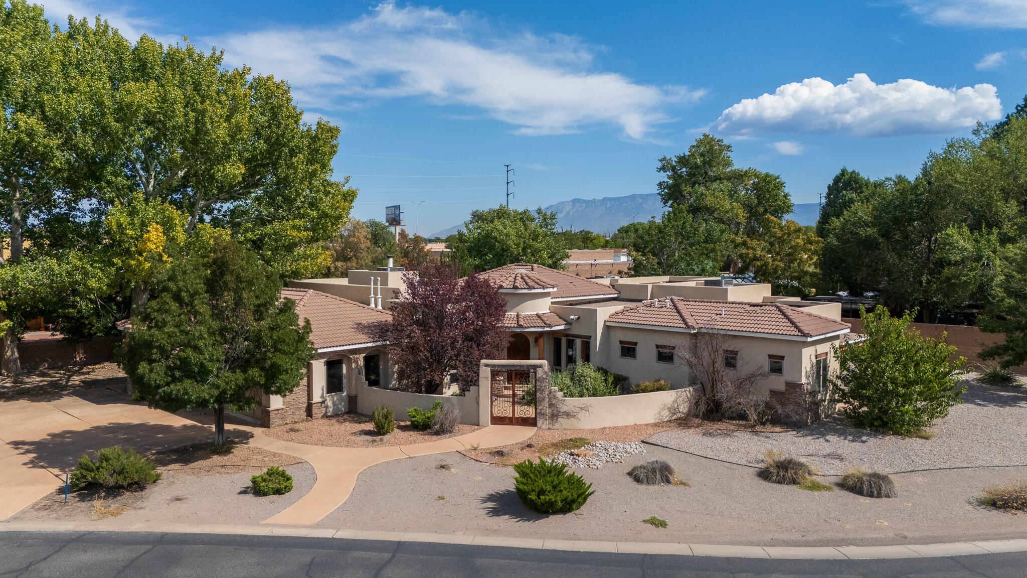 $120,000 Below Market Value. New Price! GREAT DEAL! Homes in this community valued at 1.1 to 1.5 million. Needs some work.  Selling AS IS.  Secluded Gated Community!  Enjoy the walking & biking Trails thru the Bosque & Rio Grande River. Located close to Historic  Albuquerque Old Town, SAWMILL Entertainment District, Abq Golf Country Club, Quick access to Interstate-40. As you enter the home you are greeted with High Soaring Ceilings  in main Living room, Beautiful Kitchen  Island & Granite Countertops & backsplash. 4 Bedrooms, 3.5 Baths, 4 Car Garage. Spacious 0.57 acre Lot. 2 Living areas with 2 Fireplaces 1 Kiva Style,  Office with Large Book Case. Diamond Plaster walls, Steam Shower in Master Bedroom Custom Doors.. Tree Root issue and new Roof is needed some roof repairs have been done