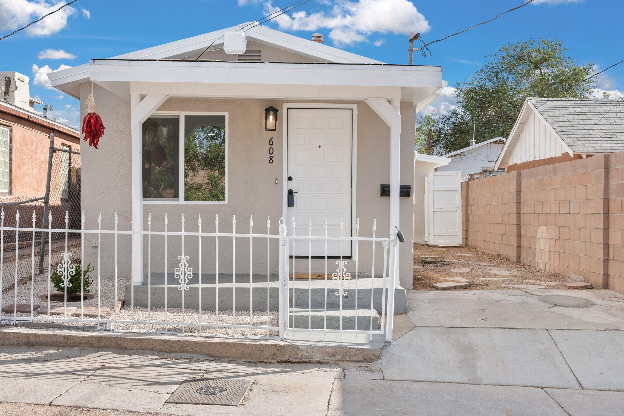 Discover this charming adobe home in the historic Martinez Town neighborhood of Albuquerque, New Mexico. This beautiful residence seamlessly blends traditional Southwestern architecture with modern finishes. Enjoy freshly textured walls, new light fixtures, and vibrant paint throughout the home. The updated kitchen features brand-new stainless steel appliances and natural light fills the space thanks to new windows, creating a warm and inviting space, new flooring throughout the space enhances the flow and comfort of the home. As if this home couldn't get any better the backyard holds potential for investors, featuring a possible casita that can serve as a guest house, rental unit, or a creative studio space, further enhancing the allure of this property. Experience the perfect mix of