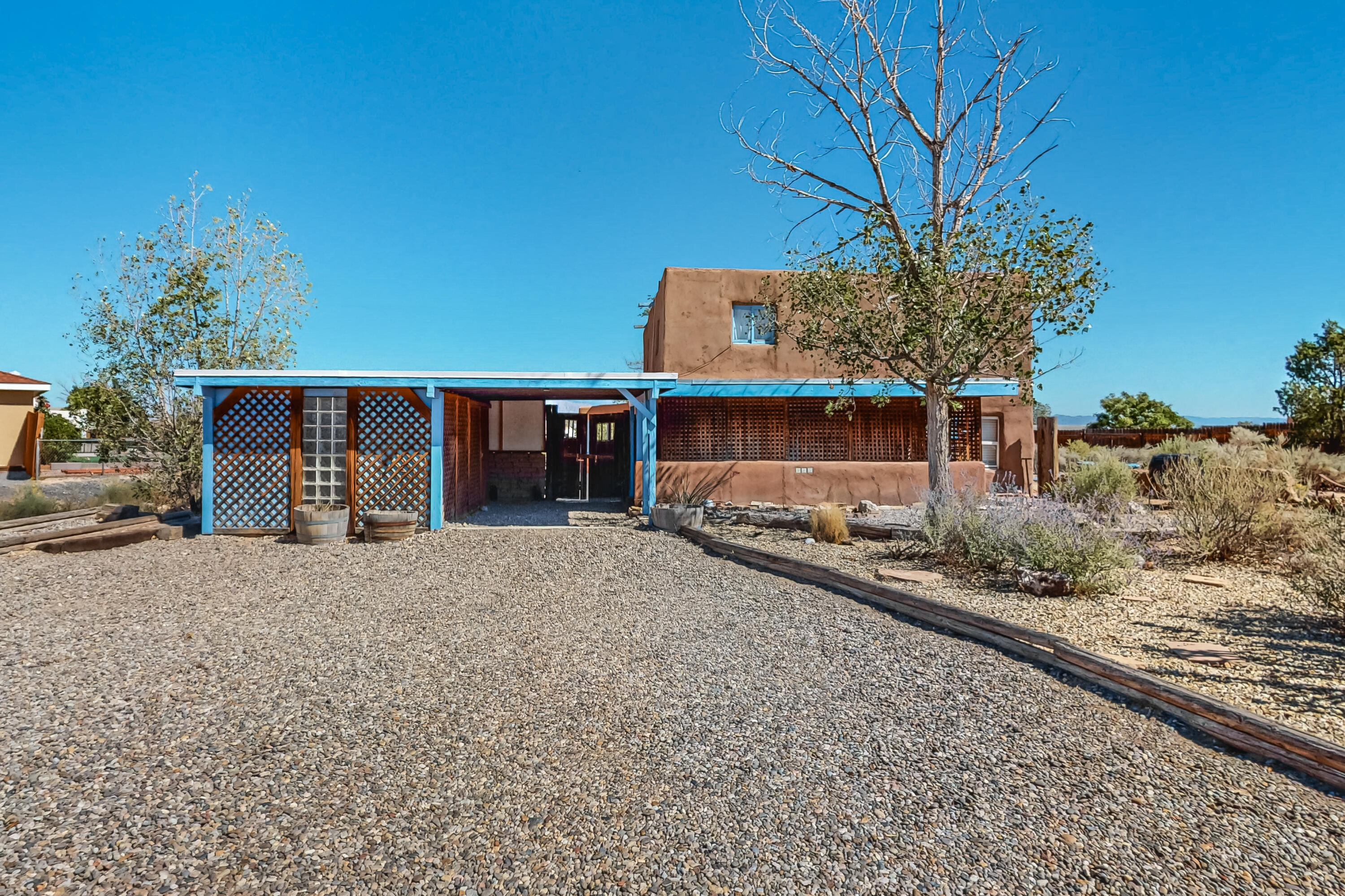 Welcome to this beautiful unique home. Situated on a half acre lot, surrounded by lush NM vegetation. Views of the Sandia's. This fantastic home features passive solar designed by the famous solar environmentalist David Wright. Beautiful massive windows to the South that allows wonderful natural light in. All adobe construction. This property has one bedroom on the main floor. A small bonus room that leads to the backyard porch. The master bedroom and third bedroom are upstairs. Home features wood and brick floors. Bring your RV and toys. as this lot is huge! Did I mention there is no HOA. This home is close to shopping and entertainment. Don't miss out on this one of a kind home!!