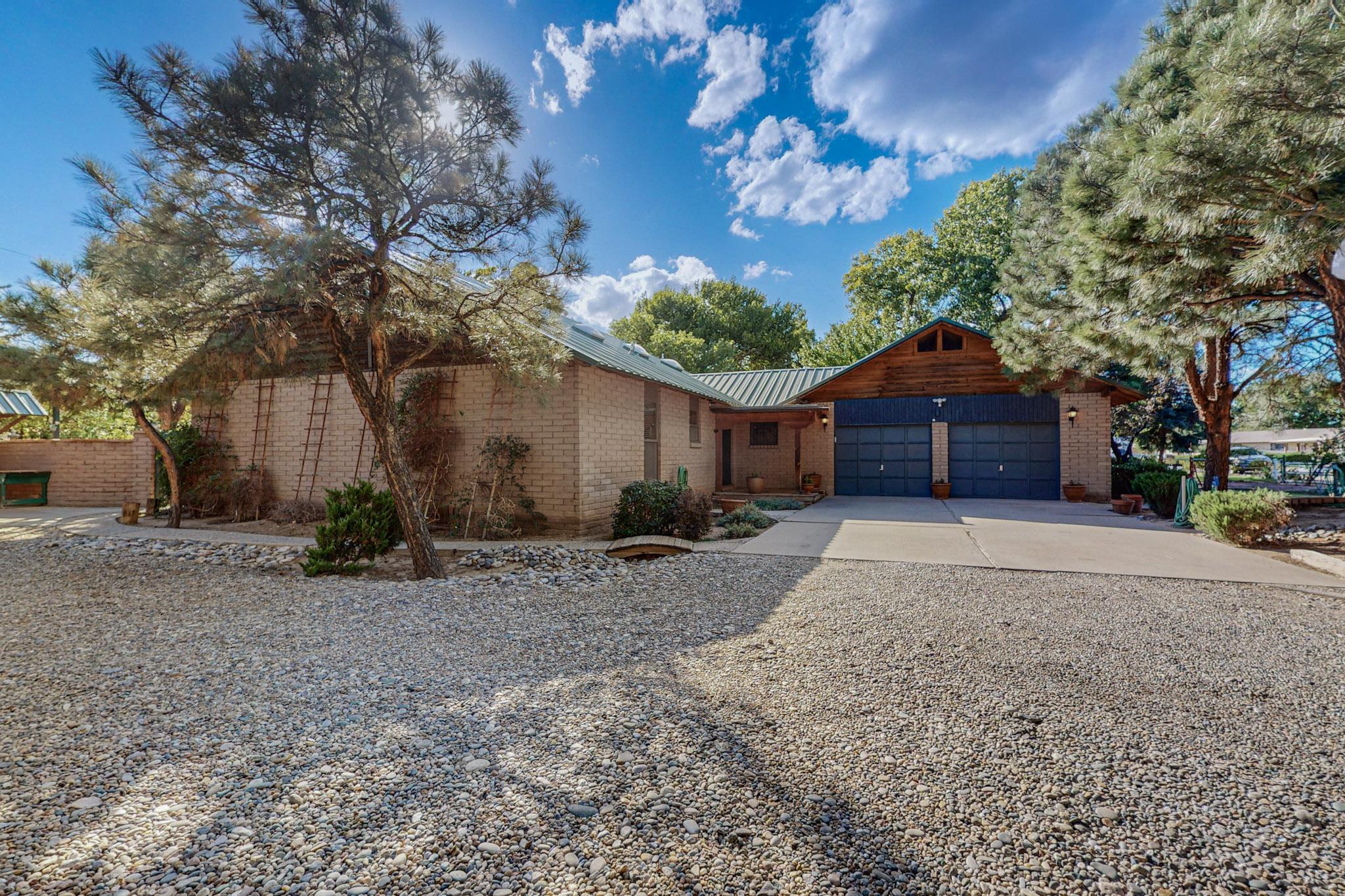 Welcome home to this gorgeous North Valley 2-story home w/horse corral. 3 bedrooms- 2 are primary, one on main level, one upstairs; 3 baths; plus bonus room! Large light & bright living room w/lots of windows & beamed ceiling. Nice sized kitchen with bar & pantry. Huge main bedroom w/gleeming hardwood flooring, room for sitting area, large balcony w/views of back yard, 3 cedar lined closets & en-suite bath. Tons of storage - 4 car attached garage PLUS a detached workshop w/ a loft and RV port. Front & back yards are beautifully landscaped w/irrigation for watering. Two stall horse corral w/bridal path in rear for easy access & loading. Tree-lined Rio Grande valley location w/lots of shopping and dining near by. Come and see this one today!