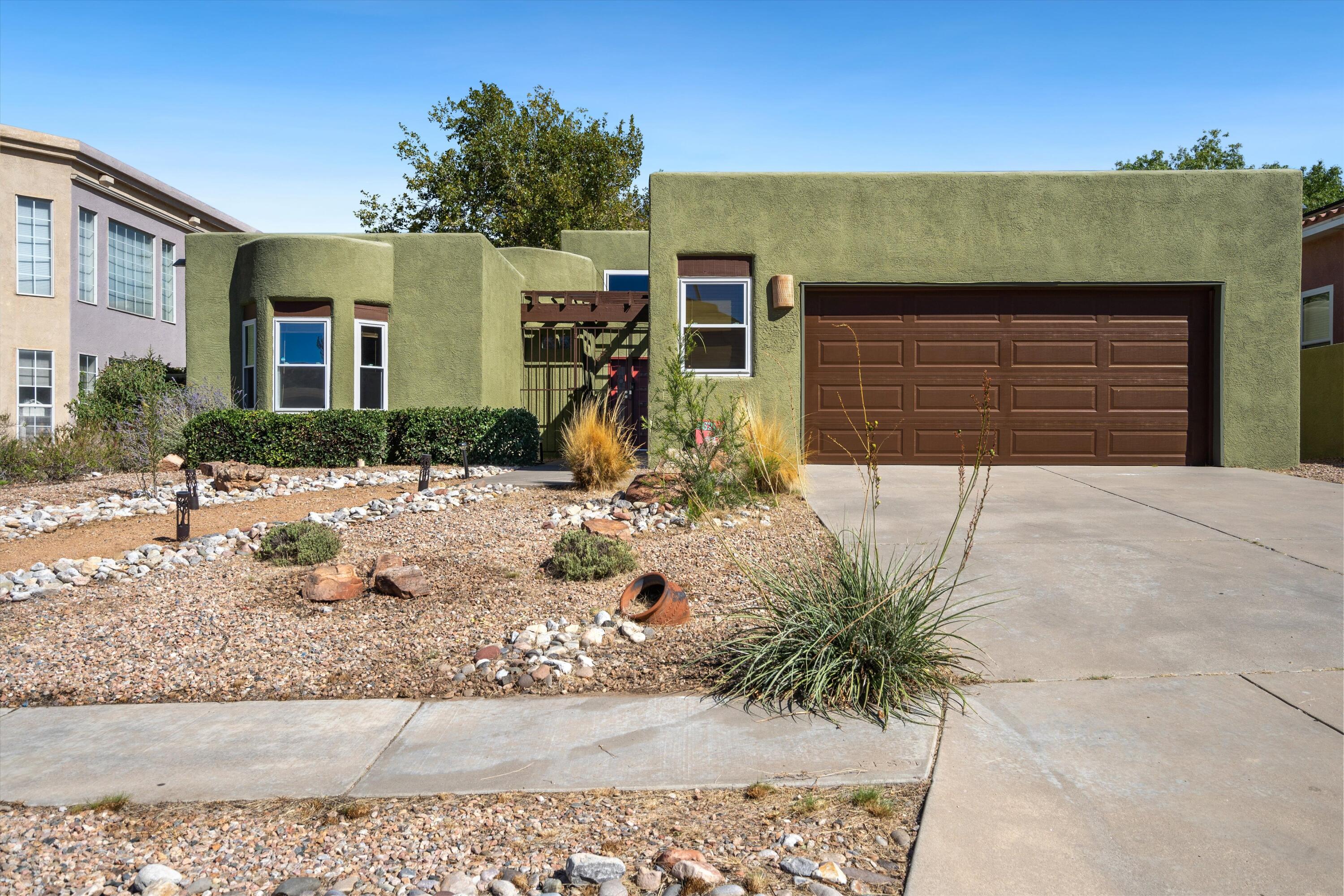 Welcome to this stunning move-in ready contemporary home in Albuquerque Acres West! At the heart of the open living area is a beautiful two-way fireplace, seamlessly connecting the cozy living space with the dining area and kitchen--perfect for entertaining. This home features multiple flex rooms, making remote work a breeze.With three additional bedrooms thoughtfully positioned for privacy, you'll find the ideal balance of comfort and functionality. Enjoy serene views and a clean backyard, perfect for outdoor relaxation. Located near highly desired schools, this home combines convenience with a tranquil setting. Don't miss your chance to make it yours!