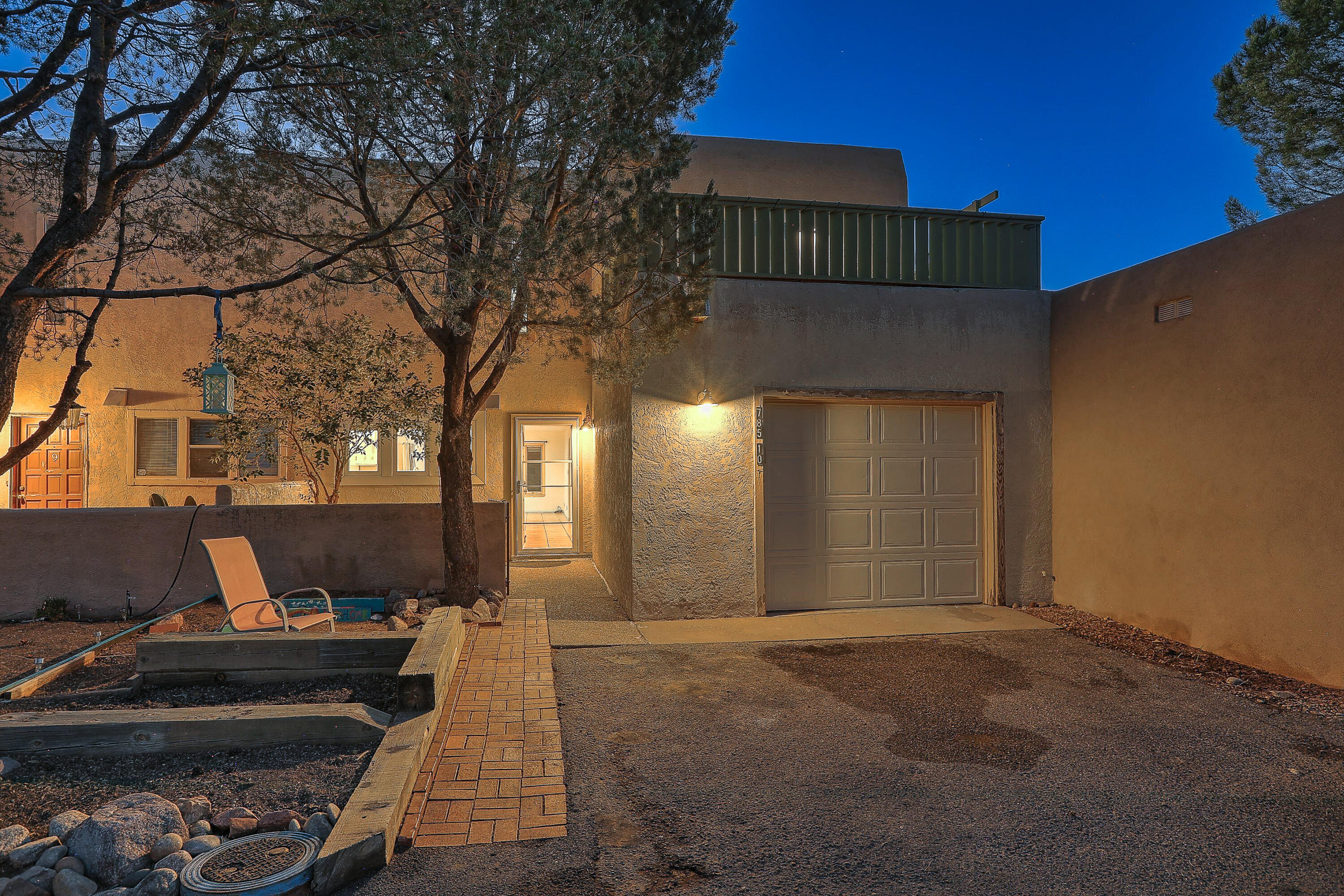 This stunning townhome offers two large balconies with breathtaking views of both the mountains and the city. Located in La Cueva school district, it's just steps from nature and a nearby park. Inside, you'll find walk-in closets, tons of skylights, and Pella windows and doors that offer energy-efficient triple panels with built-in blinds. All appliances are newer and will convey, New garage door opener and fresh paint. Enjoy fresh fruit from your own mature apricot tree. Don't miss the chance to live in this perfect blend of comfort and convenience!