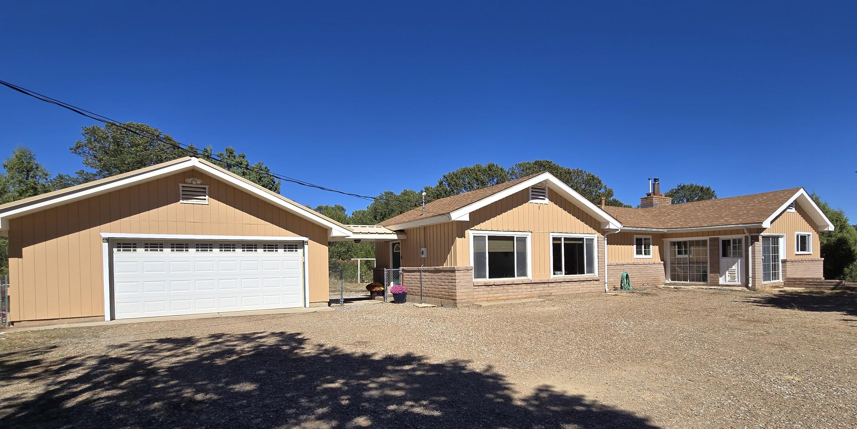 Enjoy the best of East Mountain living with this beautiful Sandia Park property! Located a short distance off Sandia Crest Road, you will be close to hiking, skiing, and high mountain beauty, but still have an easy commute to Albuquerque.  This home has a 1117 sq ft finished walk out basement with a bedroom, 3/4 bath, and kitchenette, which is not included in the declared square footage. The bright, large kitchen boasts granite countertops and a pantry. Radiant heat under tile warms a portion of the home and there are two wood stoves for those chilly mountain evenings. Beautiful engineered hardwood flooring covers the kitchen and primary living area leading to a big balcony that overlooks the property.