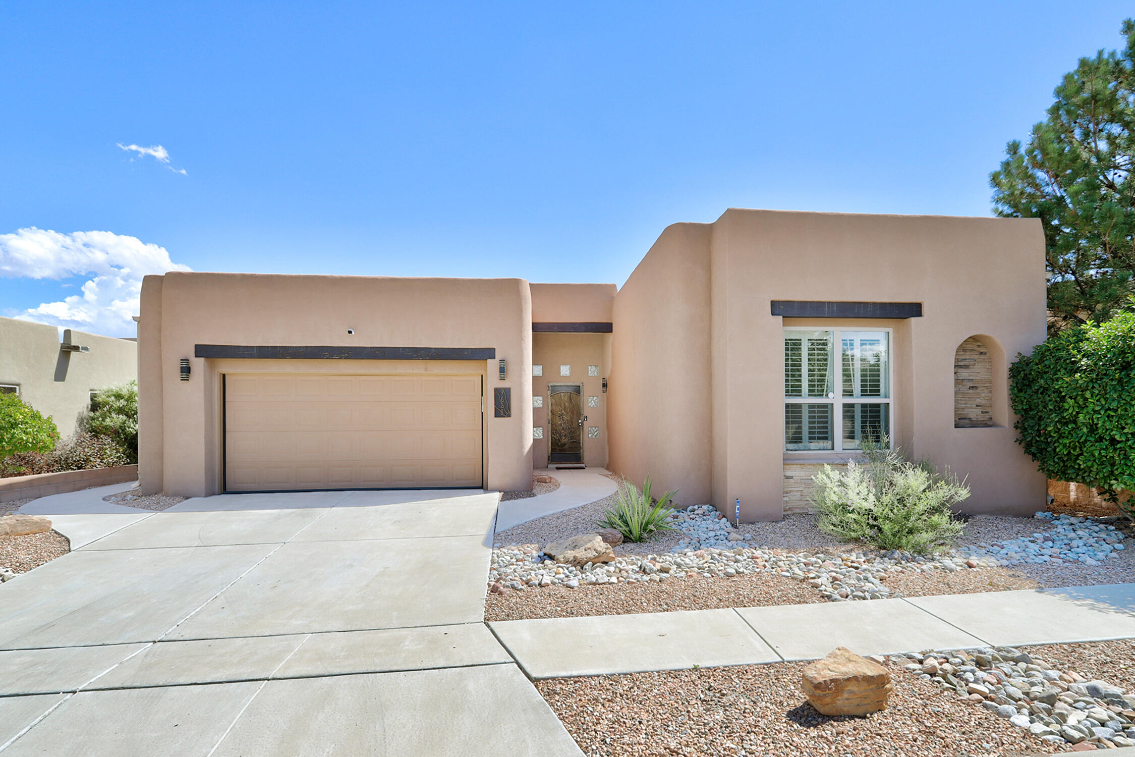 Exquisite is the word for this incredible home. No detail has been overlooked! And all to capture the incredible view! The living room, dining room, kitchen and Primary bedroom all have views. Walk into a wide entry hall with room for your artwork. Beautiful tile takes you to the living room with panoramic views of the city and the Sandias. Capture the views in the dining room & the kitchen. And what a kitchen with a large quartz island for sitting and cooking. Chef's quality appliances, lots of cabinets and counter space. Even two pantries. The master suite has amazing views too. And what an elegant bath! It will amaze you. Outside find the perfect space with grass and flower gardens, all taking in the view. Come see!