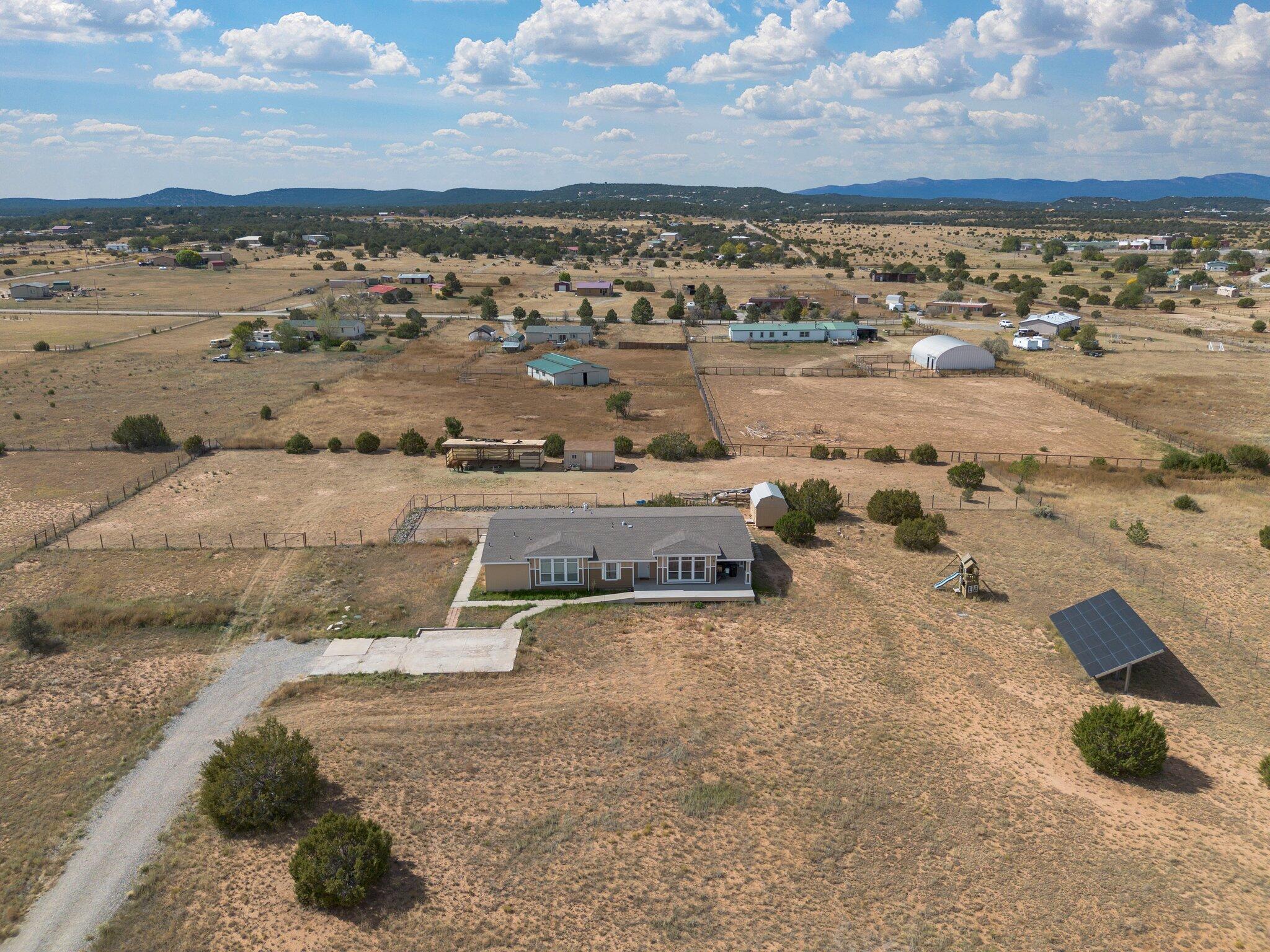 Nestled on 2.5 sprawling acres, this stunning 2698 square foot modular home offers the perfect blend of comfort and country living.  If you are an equestrian enthusiast, the 3 over sized 40 ft x 20 ft steel pipe stalls,  40 ft x 14 ft enclosed shed for supplies and the fenced area to ride and roam will check  boxes. Your doggies will appreciate the additional fenced off area for them as well. Kiddos are cared for too, with a play area!  Another shed with plenty of storage room also conveys. The home is spacious, has high ceilings, and filled with natural light. It has 2+ living spaces; den, living room, dining room, kitchen with eat in area, island, and breakfast nook plus a walk in pantry. 3 bedrooms with an office that could be a fourth bedroom round out the home. Retreat to the serene