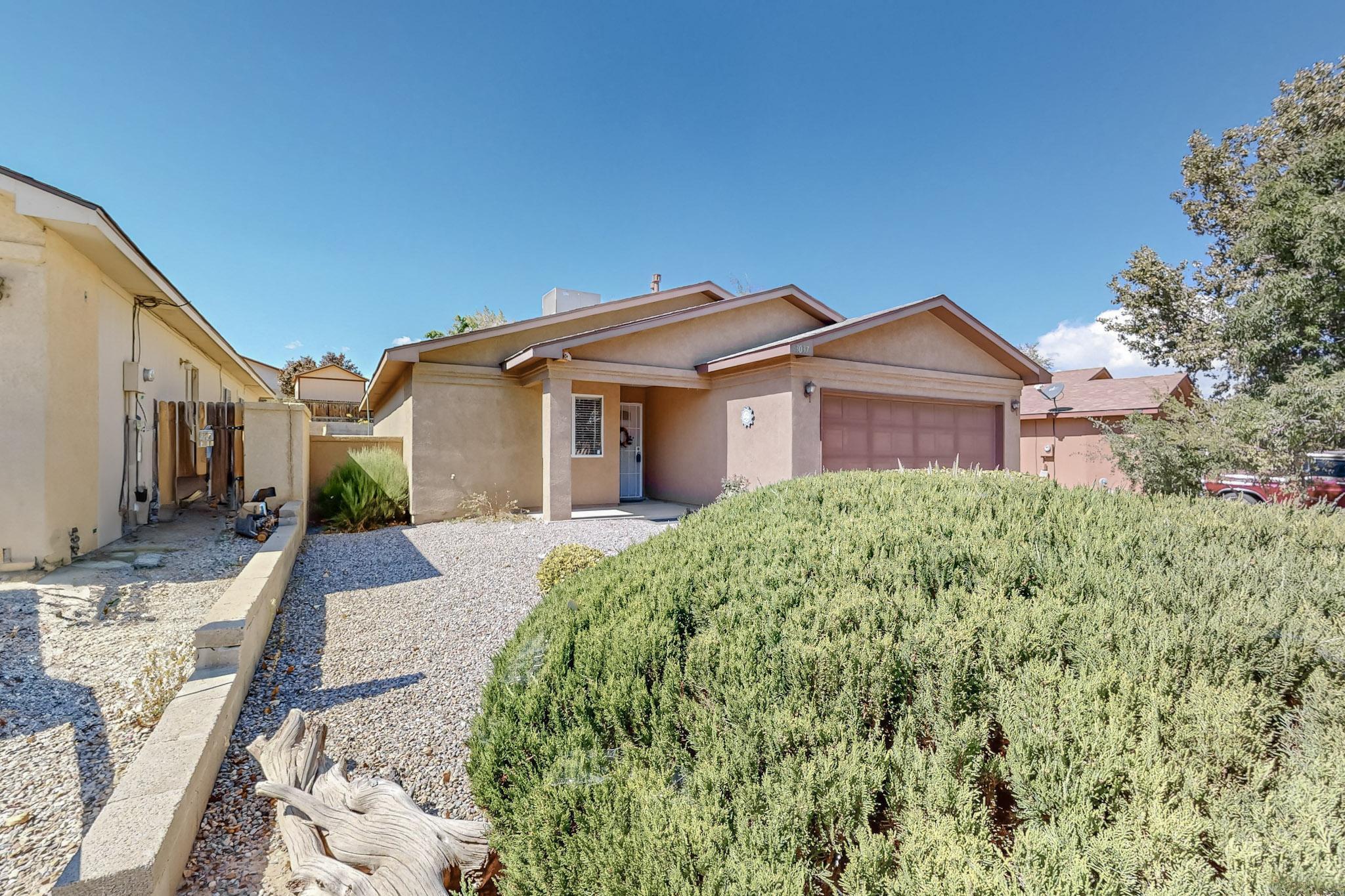 Discover this *stunning* Northern Meadows gem in Rio Rancho, perfectly located near parks, schools, and entertainment! Move-in ready, this 2-bedroom, 1-bath home is beautifully maintained with a flowing, open layout, featuring tile and wood flooring, plus stylish accent walls throughout. The spacious 2-car garage offers ample storage and a dedicated workspace for all your projects.Step outside to your expansive backyard, fully fenced and walled for privacy. It's tastefully landscaped and comes complete with a charming gazebo and BBQ area, ideal for hosting family gatherings and outdoor celebrations. Don't miss out on this opportunity--schedule your showing today!Gazebo conveys with acceptable offer.