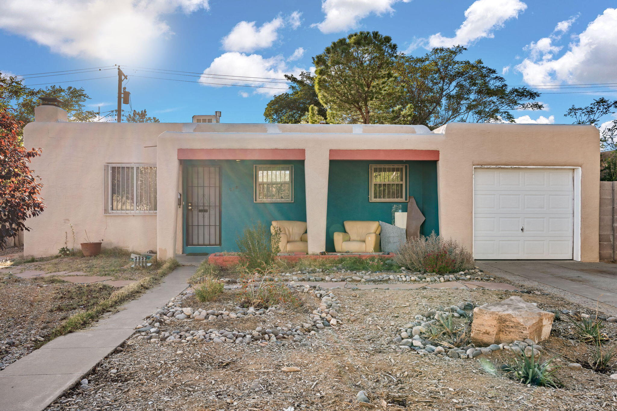 Welcome to your dream Pueblo-style home! This inviting residence boasts stunning hardwood floors that add warmth and charm throughout. Imagine cooking in the updated kitchen and unwinding in the refreshed bathroom, both designed for modern living. With new electrical work completed in 2022 and a brand-new evaporative cooler installed in 2024, you'll enjoy comfort and efficiency year-round. Gather around the beautiful fireplace on cozy evenings on your flagstone patio and tend to your flourishing raised gardens in the backyard, perfect for nurturing your green thumb and enjoying beautiful NM evenings.