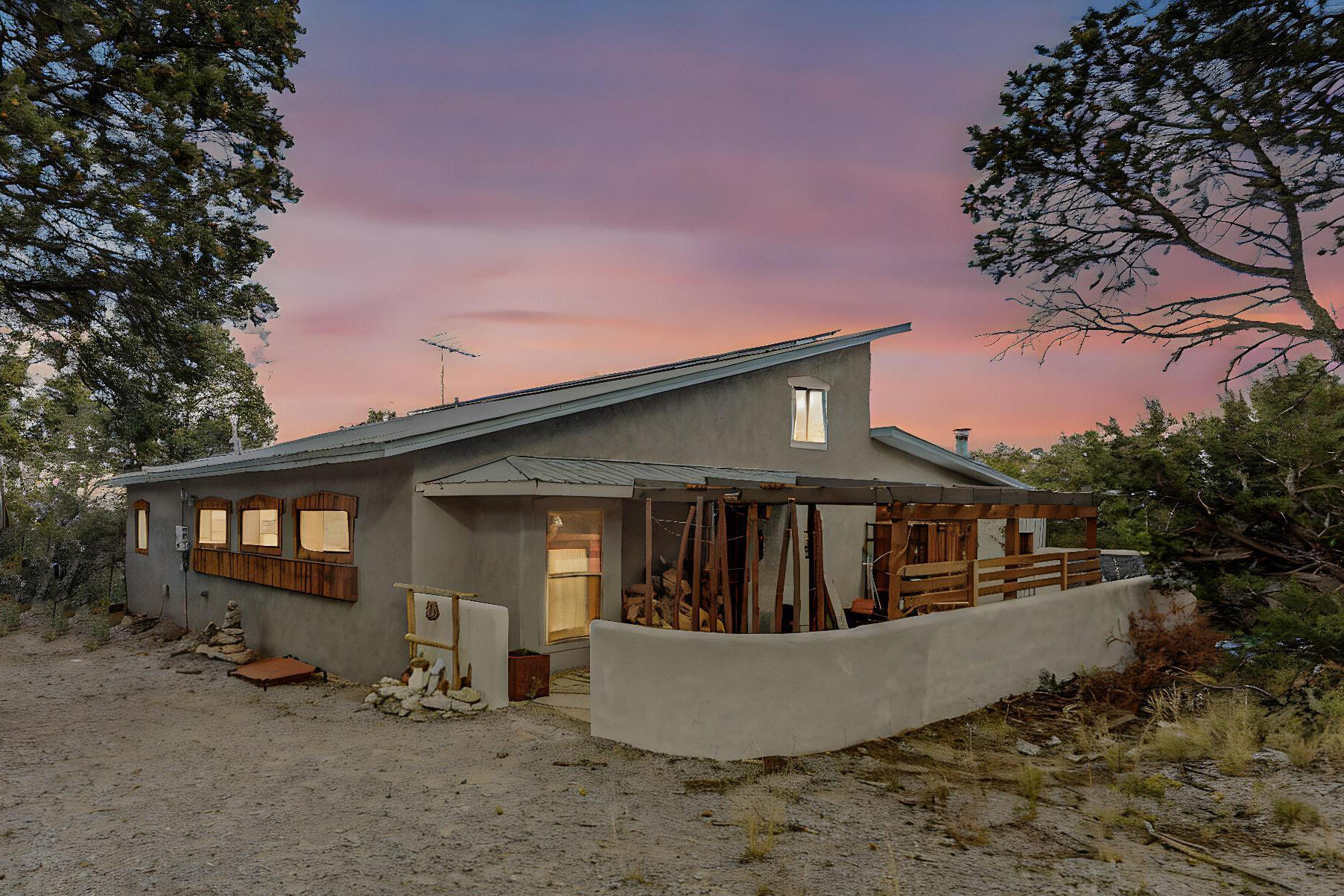 Welcome home to this Sandia Park beauty! This warm home sits on a wooded lot & boasts soaring cathedral beamed ceilings. Main house has 2 bedrooms, 2 baths, 2 living areas, sunroom, plus a loft. Fully updated kitchen with solid wood cabinets, butcher block counters, huge pantry and bar. Separate dining space/breakfast nook. Main bedroom is light and bright with access to the deck w/dry sauna & ensuite bath with double vanity & soaking tub. The detached casita has another bedroom and bath plus a living or office space plus loft storage that could be converted for more living area. .75 acres with picture views from the large wrap around deck and hidden sitting area to be one with nature. Short drive into Alb. with shopping and dining are all nearby.  Come and see this lovely home today!