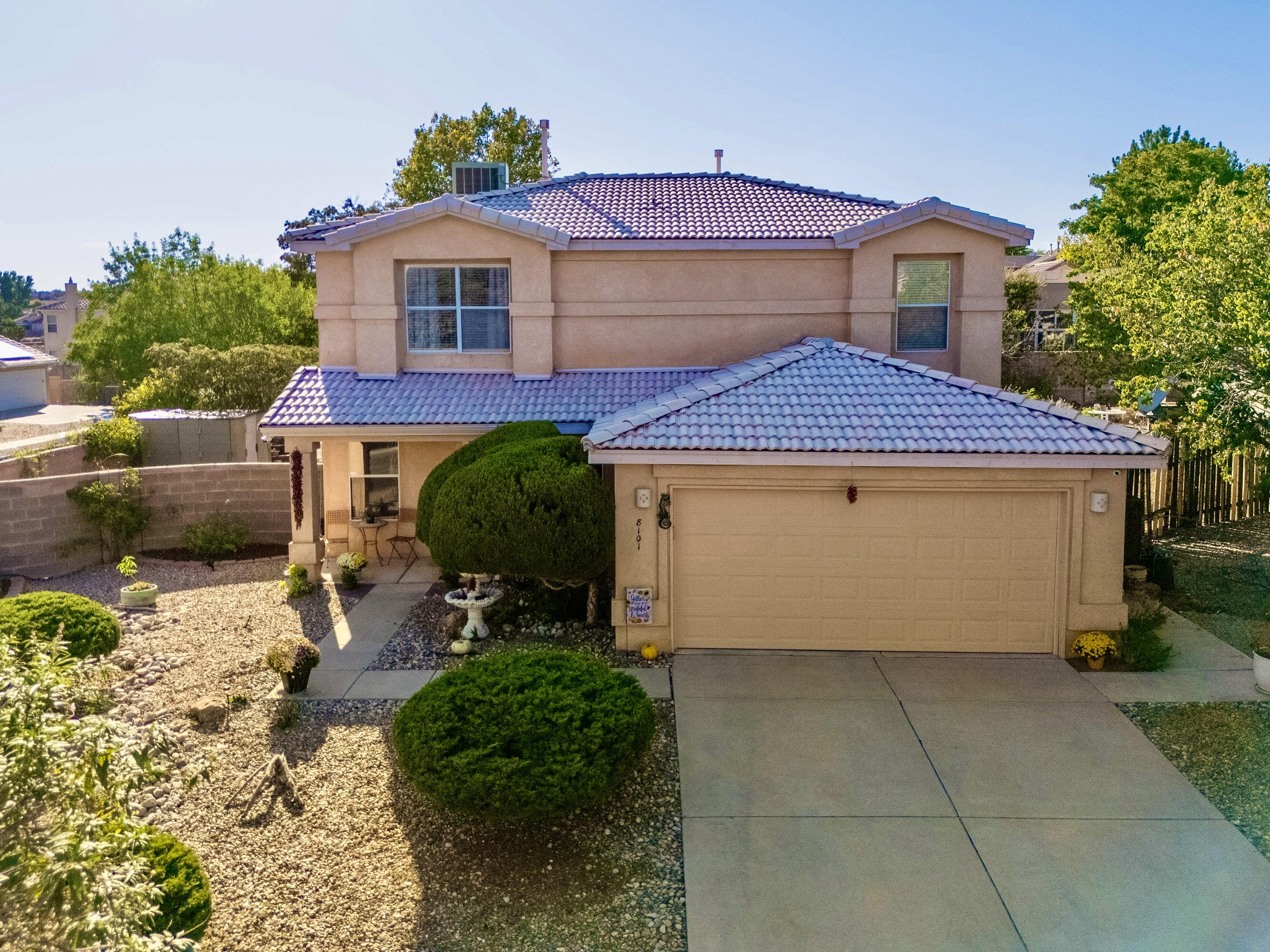 Nestled on a quiet corner lot, this could be a perfect multi-generational home with rich wood laminate flooring that graces the main level, where a flex room could be a guest/in-law suite or family room next to a 3/4 bathroom. The bright kitchen features stainless appliances, recessed lights, breakfast bar & French doors that open to a serene covered patio. The Greatroom, with gas log fireplace, flows seamlessly to the dining area. Upstairs, the owner's suite has an updated ensuite & large walk-in closet. Two additional bedrooms, one with potential as a 2nd living/media room, share a renovated hall bath with travertine floors, tiled tub surround & plaster walls. Landscaped yards, refrigerated A/C & proximity to Paseo del Norte, Coors & shopping. ***$5,000 Seller concession offered***