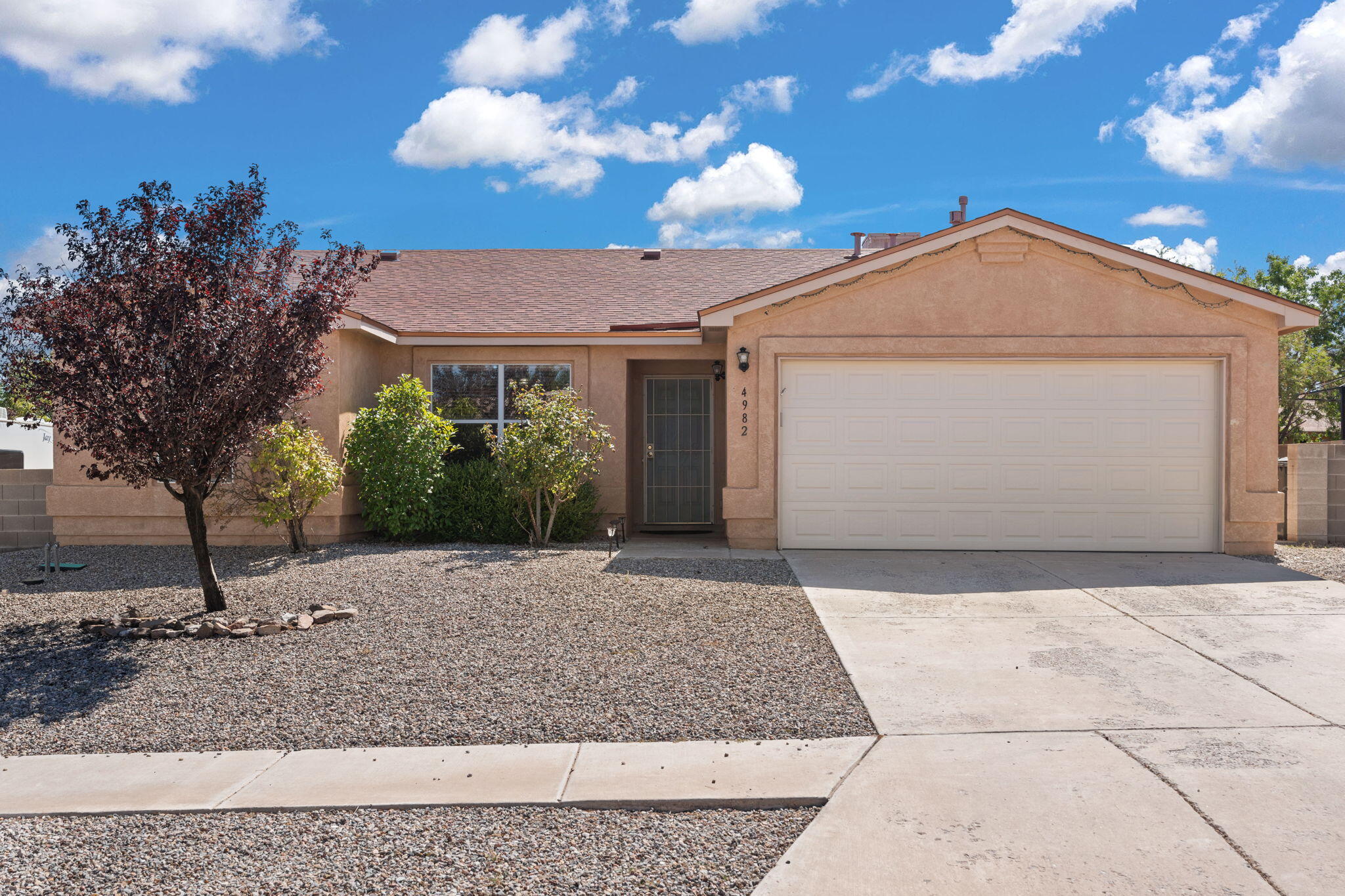 This immaculately kept home in Rio Rancho is conveniently located near shops and grocery stores. The interior features updated flooring, easy-to-maintain tile and warm linoleum floors throughout the living and bedrooms. No carpet anywhere in the home giving the opportunity to choose your own rugs. Low maintenance SW landscape in both the front and walled backyard provides a clean and modern look with irrigated trees. The home has been meticulously cared for, creating a welcoming atmosphere and move-in-ready! Kitchen appliances convey, as well as the water softener. Owned Solar provides low electricity bills. Schedule a showing today!