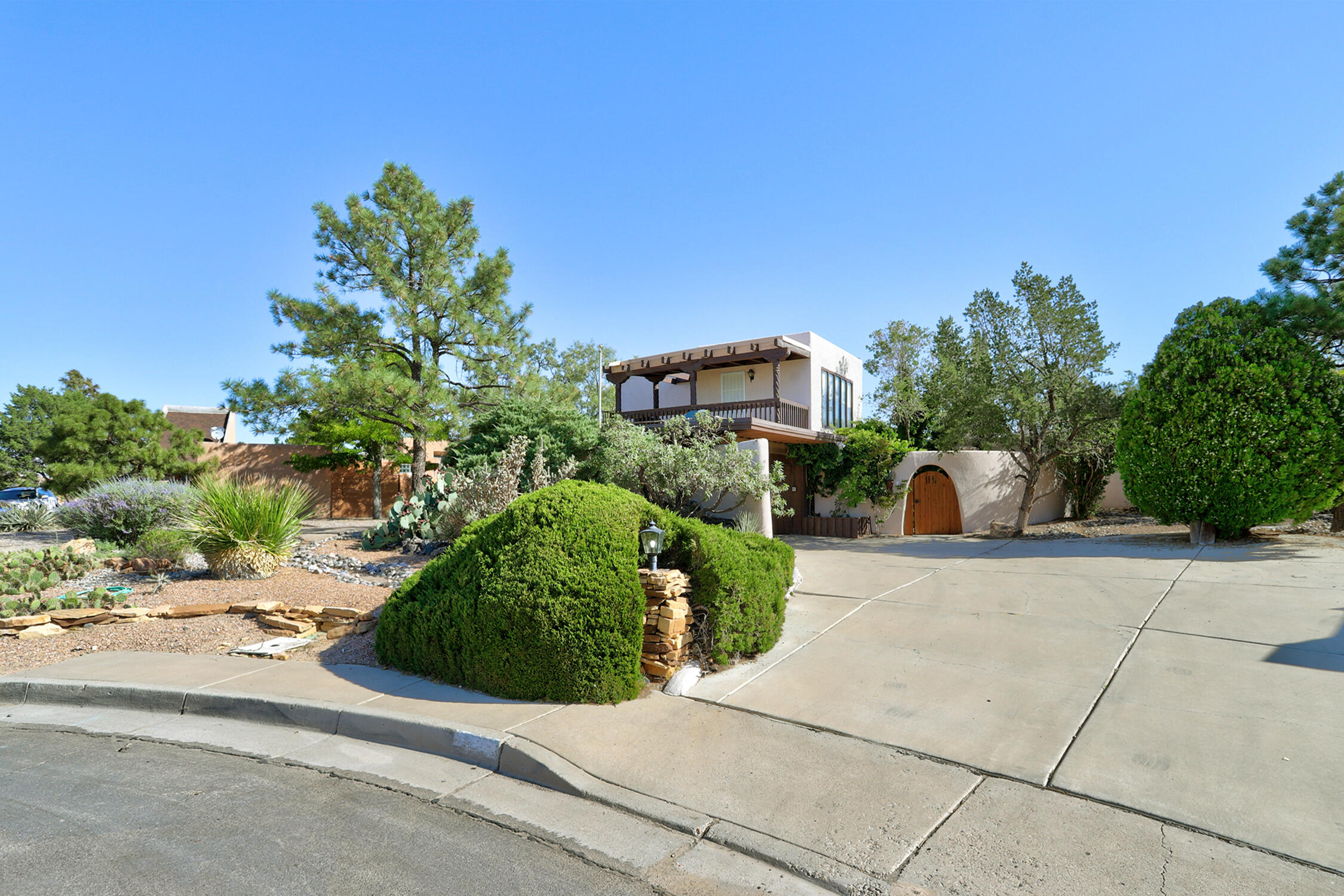 The most fantastic views!  The mountains and the Rio Grande bosque are laid out in front of you in a spectacular display! Bring your imagination when you see this unique and slightly quirky home.  Built by Iver Williams, this ''Stack Sack'' constructed home is truly one of a kind.  Views from the large breakfast nook, kitchen and huge living room are unbeatable.  Lots of flex spaces for office, library, play areas etc.  The one-bedroom apartment /casita is separate and accessible by a spiral staircase.  Two large patios for outdoor entertaining...Charming courtyard entry.  Brick floors, etched glass panels from the Albuquerque Country Club, two custom fireplaces and lush southwestern landscaping complete the package.