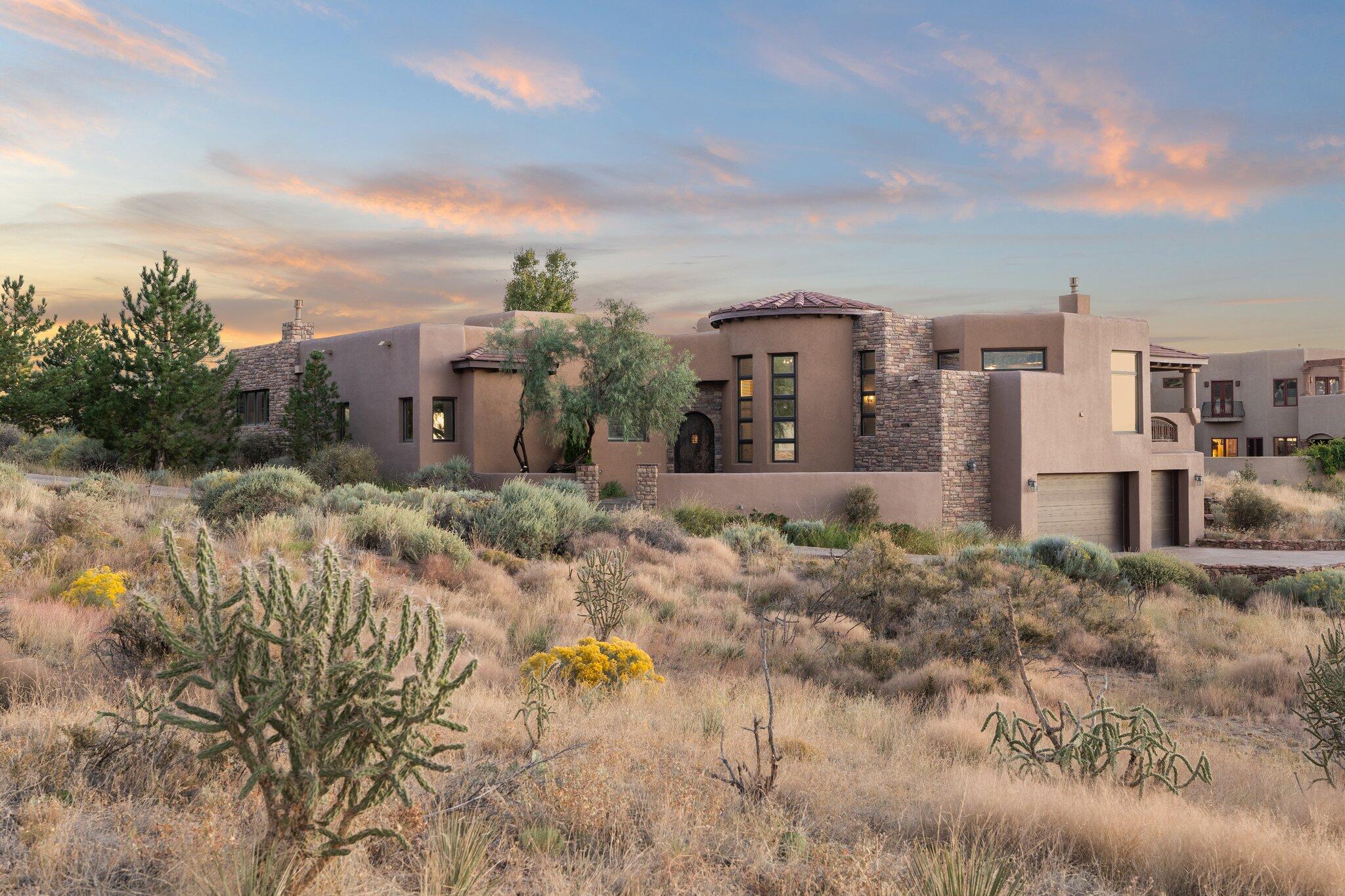 Breathtaking High Desert Home situated on a premier 0.75 Acre estate offering unparalleled views of the Sandia Mountains and City Lights! Grand Rotunda entry, coffered ceiling and custom stone accents. Built-in speakers/ surround sound in living room. Gourmet Kitchen with custom alder cabinetry, granite countertops and professional grade stainless steel appliances. Elegant finishes- crown molding, designer lighting, and custom sommeliers closet. Resort Inspired Primary Bathroom. Premium Updates include TPO Roof (2021), Solar, Refrigerated Air Units (2021), Custom Driveway (2022), Pool Cover (2024), Tinted Windows, Tankless Hot water Heater. Entertainers Dream Backyard Oasis- Private Patio with upgraded Built-in Bose Speakers, Luxurious Pool and Hot Tub showcasing Dramatic Sunset Views!