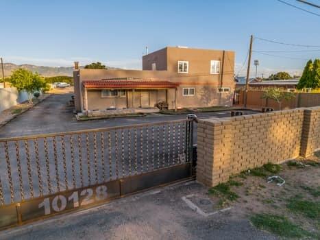 OWNER FINANCING! Panoramic mountain views from your private balcony! Privacy fencing includes 6 foot high adobe wall in front and ditch side, custom artistic security rolling gate with address on 2nd Street entrance with remotes.  MRGCD ditch is south side boundary with irrigation rights.  Fruit trees on the property include peach, apple, plum and cherry.  New Propanel fence on north side.  Zoned A-1 (agriculture), this versatile property may have many uses including as an Albuquerque base for balloonists, classic cars, horse facility, contractors warehouse and yard OR??   Room for a casita. Ideal proximity to Albuquerque International Balloon Fiesta, located due west of balloon park center field. Home has new thermal french doors, windows with home depot lifetime warranty and roof