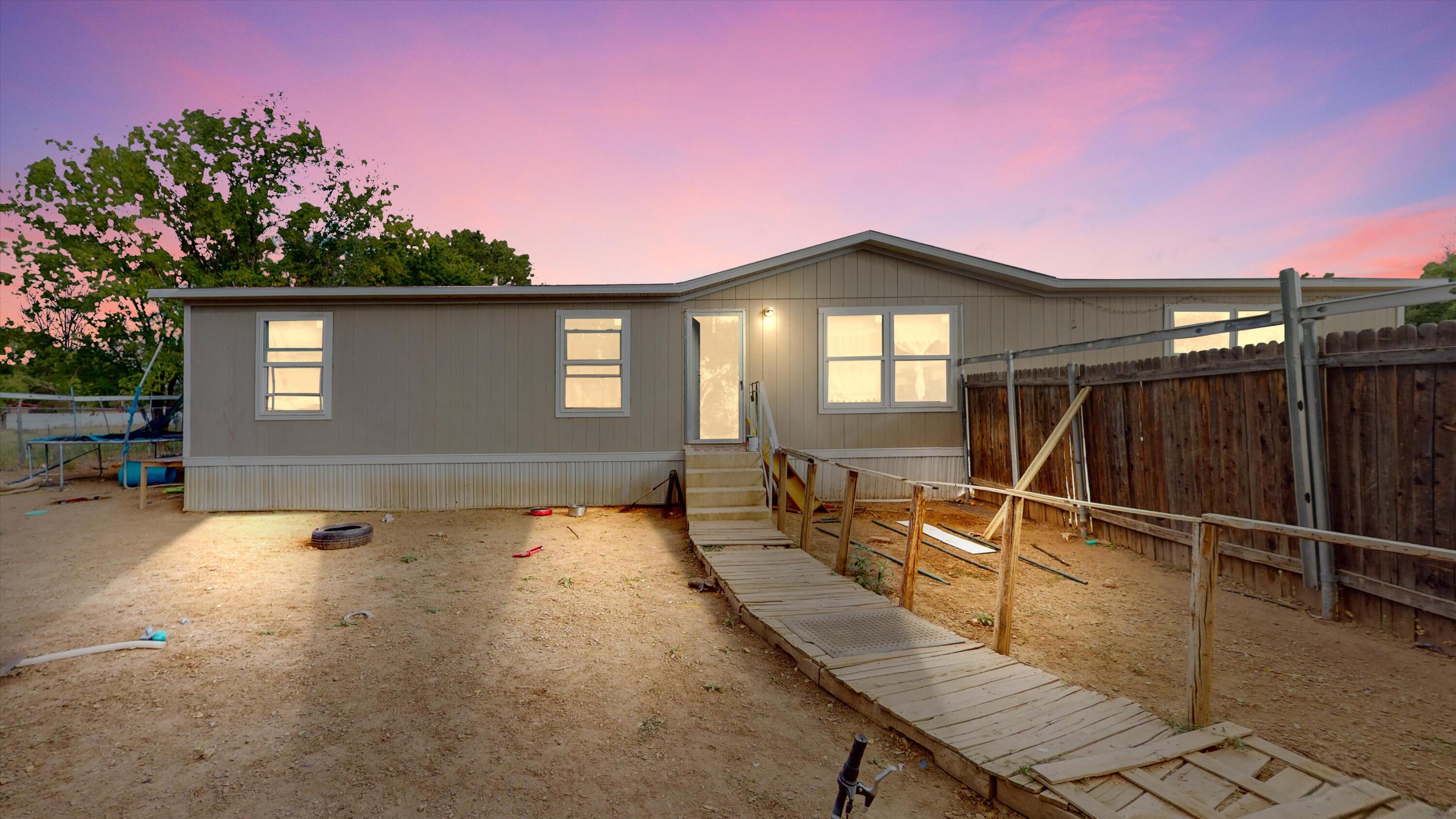 Welcome to 308 La Promesa! This affordable double-wide manufactured home, built in 2019, combines comfort and functionality. The open floor plan is perfect for entertaining or relaxing with family. The oversized primary bedroom includes an ensuite bathroom and a spacious walk-in closet, offering plenty of room to unwind.Stay comfortable year-round with refrigerated air conditioning. The home's convenient location provides easy access to I-25, making commuting simple and keeping local amenities within reach.