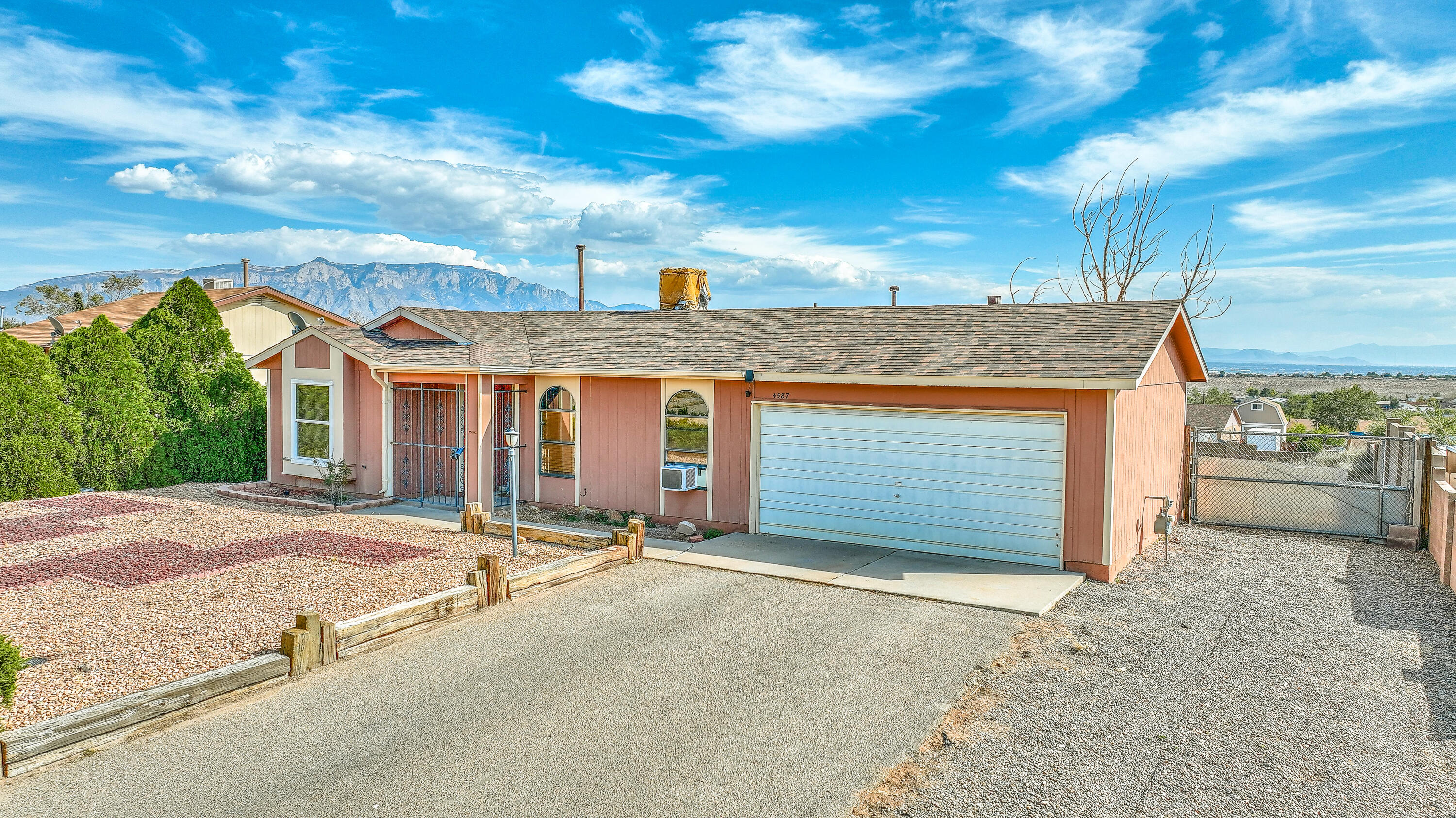 Wow!  Roof replaced September of 2024 with million dollar mountain views!  Very clean and crips 2 bed 1 bath WITH 2 CAR GARAGE and backyard access!  What a brilliant find and for the price.... go see it before it sells!  Backyard access offers extra space for toys like boat, RV etc, and the mountain views offer a perfect place to watch next year's balloon fiesta!