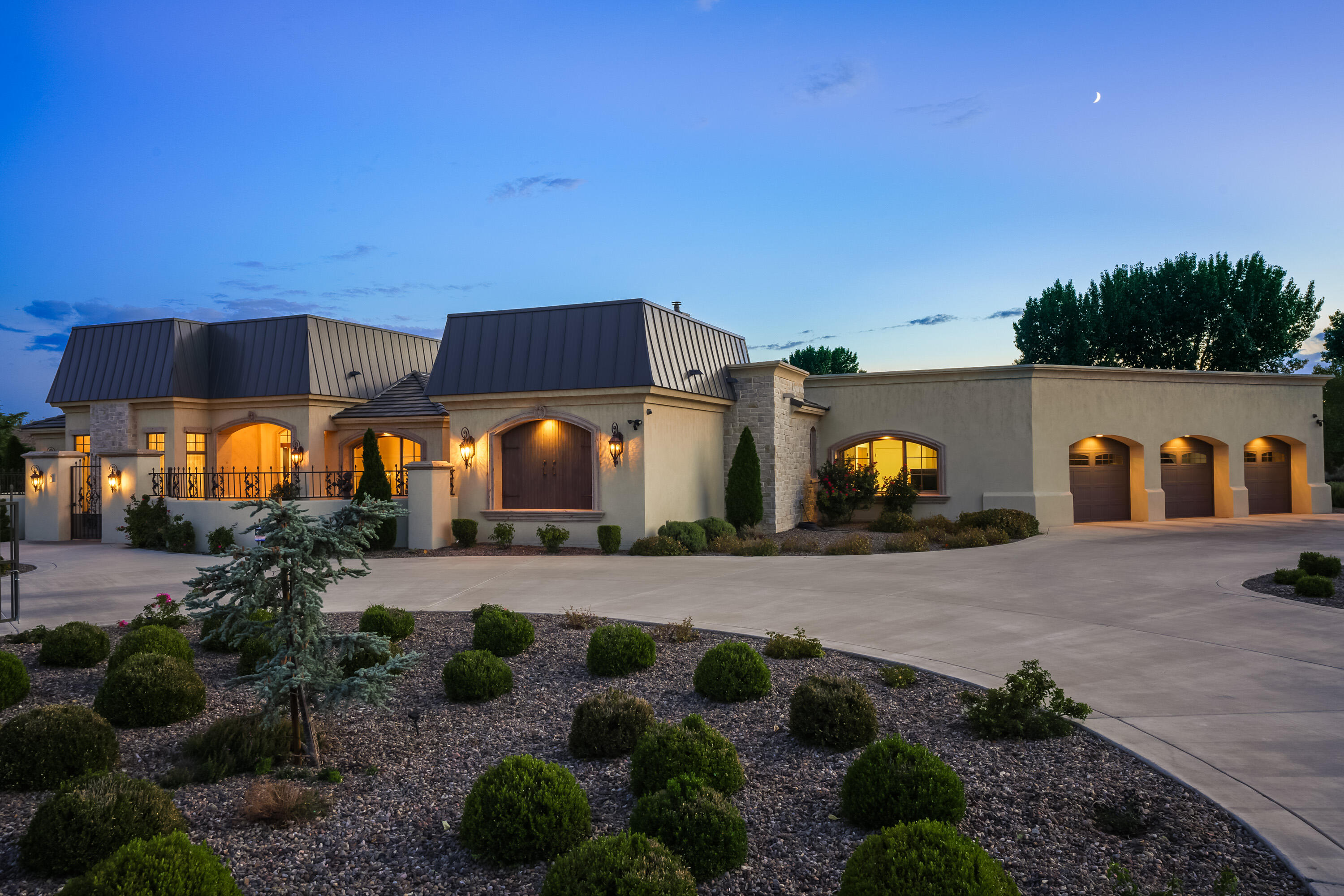 This elegant estate was inspired by classical French architecture. Manicured formal gardens with trickling fountains, beautiful bronze sculptures, and cantera stone accents create an atmosphere unlike any others in Albuquerque. The interior of the home features classical detailing such as backlit coved ceilings, traditional millwork, 4 cast concrete fireplaces, beautiful wood doors, tall windows, and intimately scaled spaces. High end features include exotic imported marble, Plyrich and Waterworks plumbing fixtures, Schonbek crystal chandeliers, backlit onyx countertops, and handcrafted furniture grade cabinetry. The home features 3 bedroom suites, a home gym which could be converted into a 4th bedroom, a home office, and formal and informal living and dining areas. Truly One of a kind!