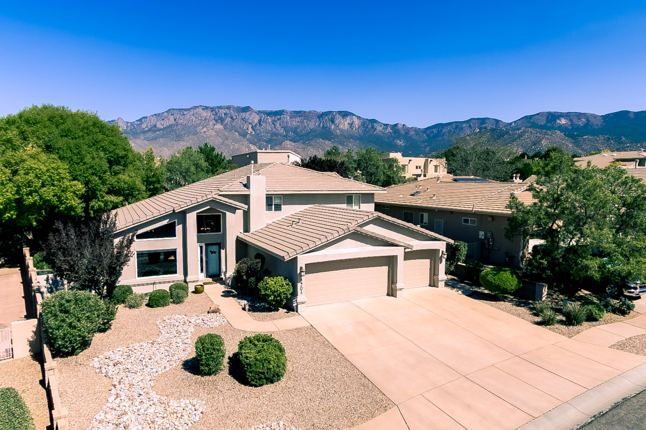 Fabulous 4 bedroom, 3 car garage home with a custom inground gunite swimming pool on a large Cul de sac lot in High Desert Albuquerque! This home features a open floor plan w/soaring cathedral ceilings & the owners suite downstairs. The kitchen includes updated level 5 Patagonia granite counter tops w/granite backsplash, monogram stainless steel appliances w/built in convection oven, 5 burner gas cooktop, convection microwave & ''ventahood'' exhaust. The spacious owners suite features a updated garden tub, walk-in shower, dbl vanities w/granite counter tops & large walk-in closet. 3 large bedrooms upstairs & a deck w/mountain views. The extraordinary backyard is perfect for relaxing & entertaining with a gunite pool, built in hot tub, open & covered rear patio, sectioned off grass area.