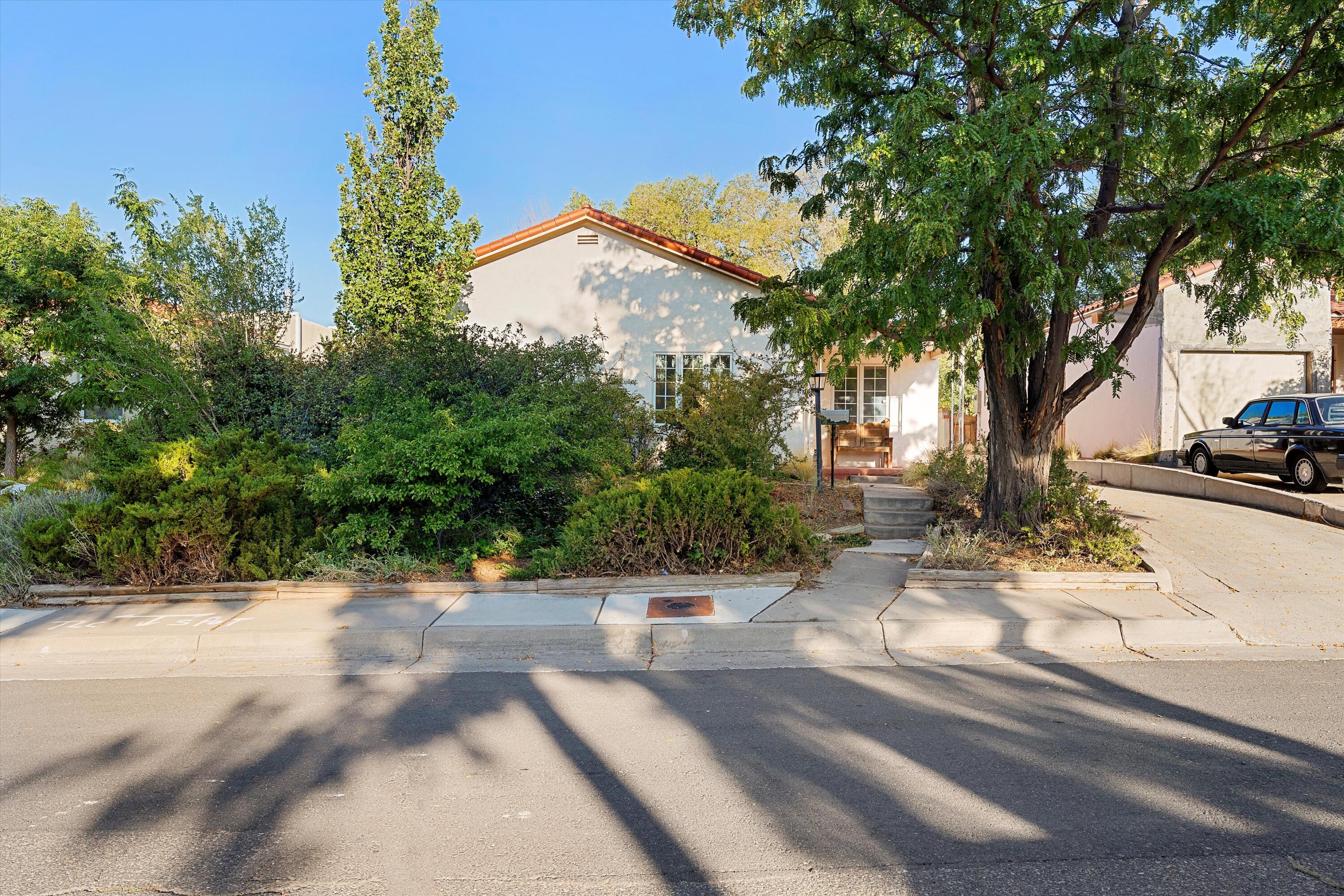 Welcome to this charming UNM home in the popular Monte Vista neighborhood.  Recent improvements include a new sewer line and new roof with warranty. This home features newly refinished hardwood floors, a spacious kitchen, and a 3rd room which could make for a great office or flex space.  Nice size kitchen with lots of storage & a brand new dishwasher.  Laundry room is spacious and has lots of built in storage.  Large backyard with mature landscaping all around.  Electrical has been upgraded as well.  Just steps to Monte Vista Elementary and Nob Hill.  Location location location!