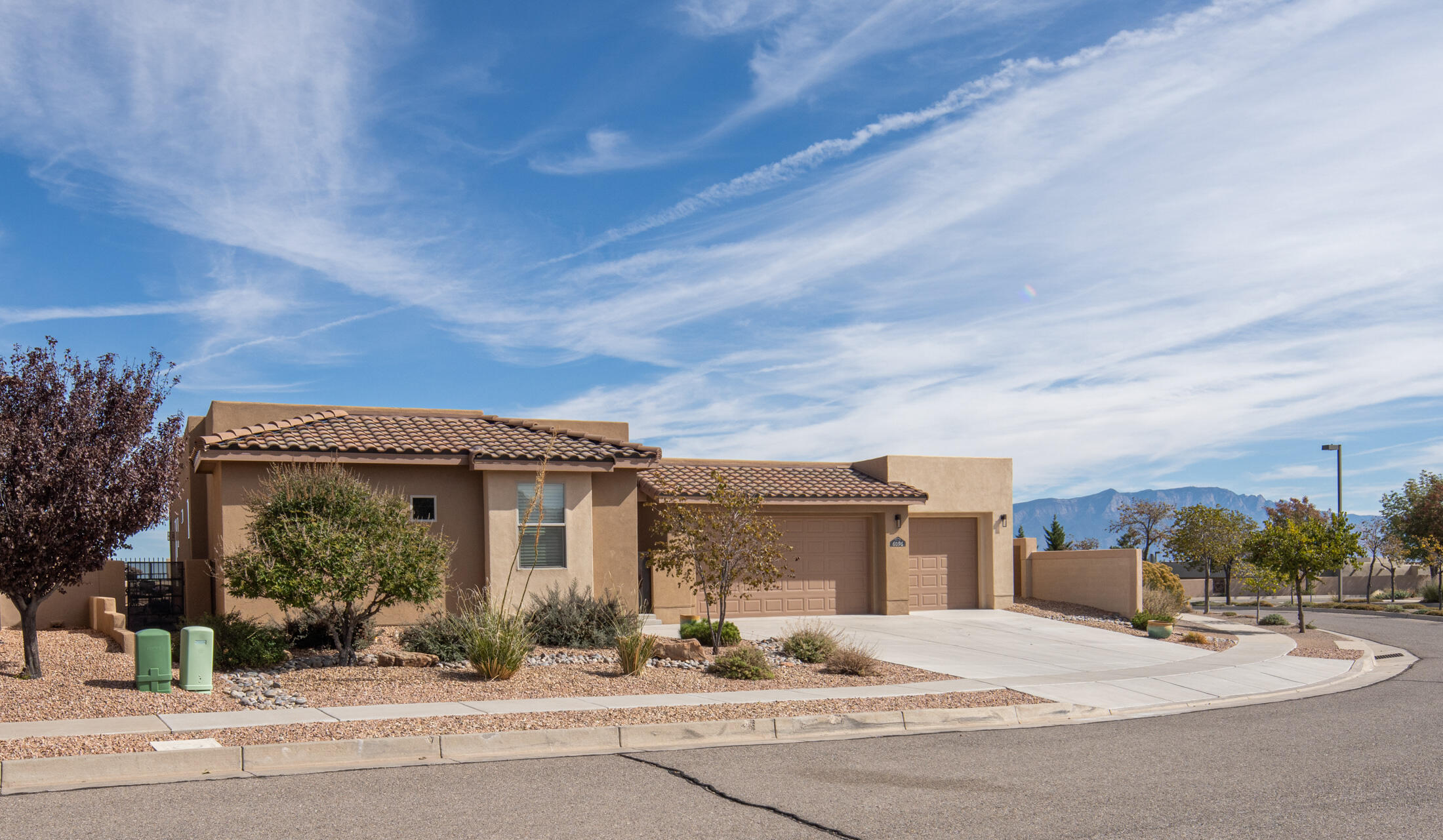 Your perfect oasis in the Mariposa community of Rio Rancho is move in ready. This beautiful 4-BR, 3-Bath gem offers a 4-car garage with epoxy floors. The interior highlights a gourmet kitchen that effortlessly flows into the dining & living areas, all anchored by a stunning two-way gas fireplace, with storage galore & views of the Sandia Mountains. New tank-less water heater, remote control blinds, a whole-house generator, & an Eco water softener are icing on the cake.This home is a seamless blend of style & function. The outdoor space part grass, part xeriscape paired with a peaceful courtyard is perfect for soaking up the New Mexico sun. Hiking & biking trails at your doorstep. Don't miss the  community center with 2 pools, full gym & yoga, zumba & pilate class. Restaurant opening soon!