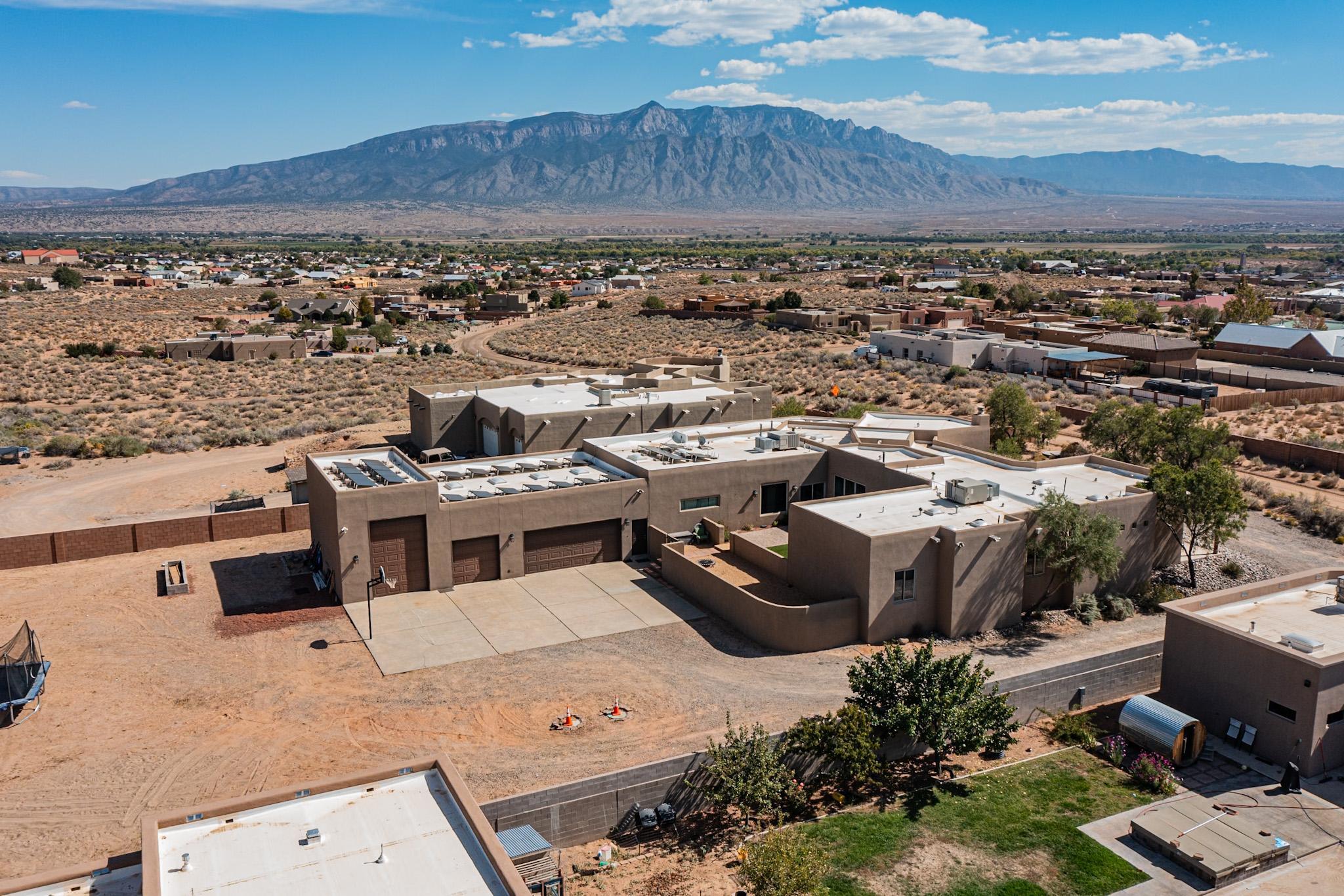 Welcome to your dream home in Rio Rancho, This stunning 4,388 square foot residence boasts 4 spacious bedrooms and a dedicated large media room, perfect for entertaining or relaxing with family. The expansive layout provides ample room for gatherings and everyday living. Enjoy breathtaking views of the Sandia Mountains from multiple vantage points throughout the home. The large windows flood the space with natural light, creating a warm and inviting atmosphere. The property also features a remarkable 4-car garage, with one bay designed specifically for RV storage--ideal for adventure enthusiasts. Plus, the paid/owned solar panels ensure energy efficiency, keeping your utility costs low while contributing to a sustainable lifestyle. This home combines luxury, comfort, and stunning natural..