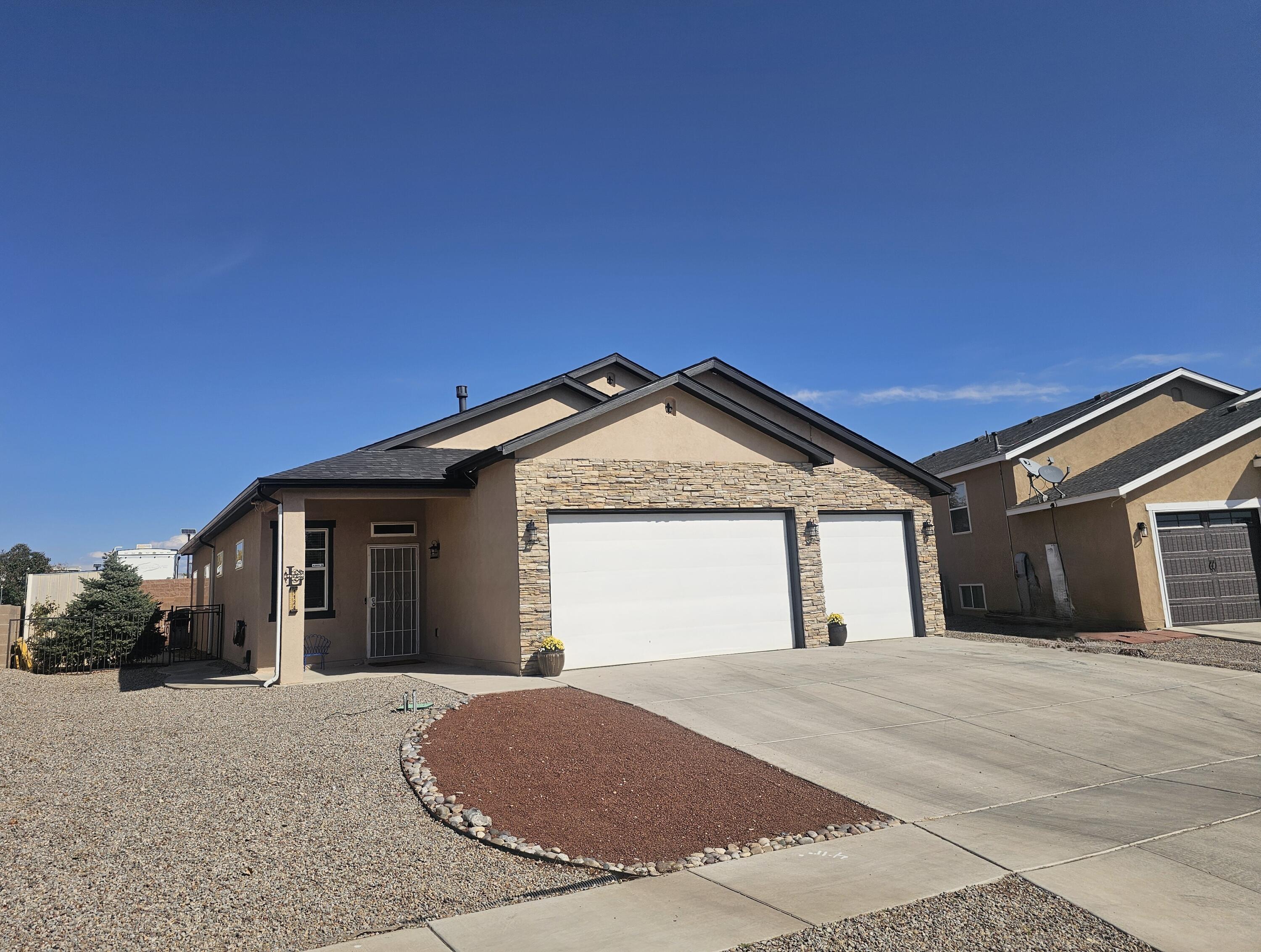 Welcome to this stunning split-level gem in the highly sought-after Yucatan at Cabezon Community (No HOA)! This rare 4/5-bedroom, 3-bathroom, 3-car garage home spans over 2,800 sq. ft. and showcases exceptional pride of ownership with custom upgrades and thoughtful design throughout.This home features a new roof installed in 2020 and solar panels, adding both value and energy efficiency. The spacious 3-car garage includes epoxy flooring, custom shelving, a work area, blown-in insulation, and additional attic storage. Inside, you'll find updated ceramic tile flooring in the living and dining rooms, along with expansive custom Hickory cabinetry in the kitchen, dining room, office, and wet bar. The kitchen boasts an abundance of cabinet space and storage.