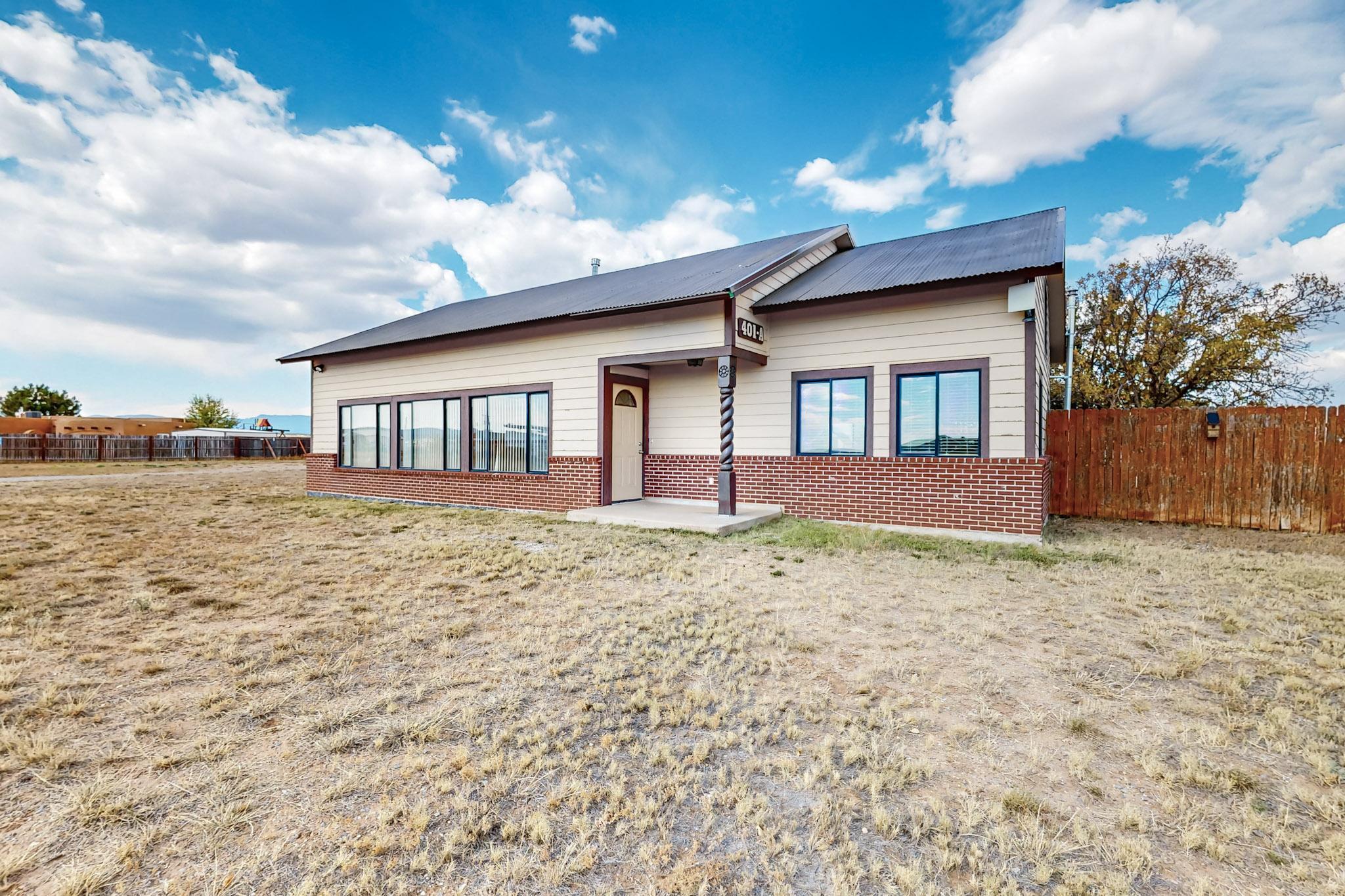 Impeccably maintained custom home in the heart of Edgewood, NM! This split-level home has had many incredible updates in recent years, including a full kitchen remodel, bathrooms, flooring, paint, you name it! The pellet stove is on a thermostat and provides warmth throughout the entire home. High ceilings in the living room and the loft, with tons of natural light which creates a warm and inviting space.  The loft offers the potential to turn this home into a 3 bedroom. Sitting on over 2 acres with beautiful views of South Mountain, there are multiple outbuildings, including a chicken coop, a shed with electricity, and an incredible nearly 1000-square-foot workshop with 300 feet of loft space, complete with multiple heat sources.