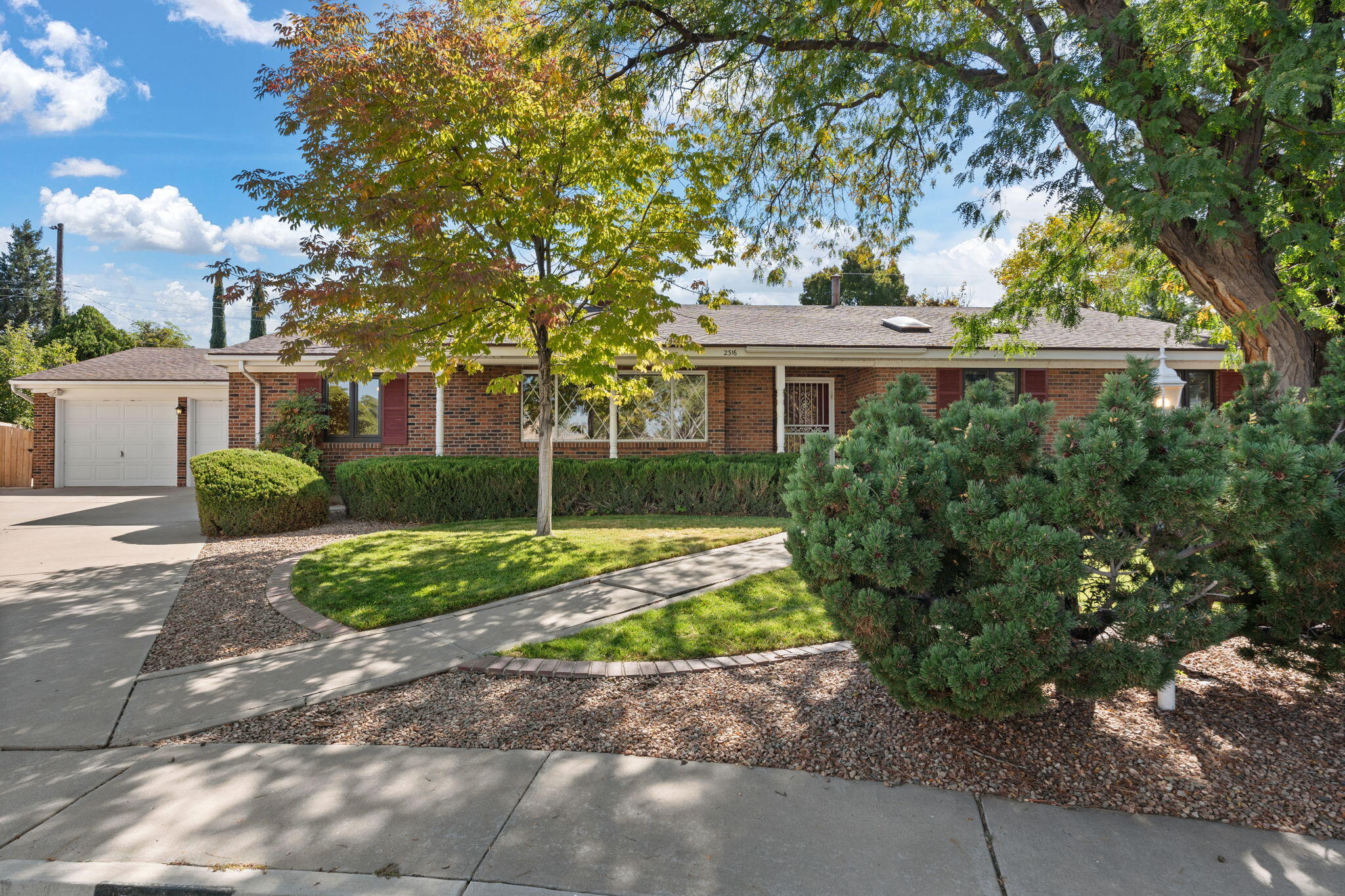 Welcome to this charming red brick 4-bedroom, 2.5-bath mid-century gem nestled in the desirable Netherwood Park neighborhood. As you step inside, you're greeted by a spacious living room with a large picture window and a cozy brick fireplace. The adjoining dining room has ample space to host fabulous dinners at a large table.  The family room offers a warm and inviting space for relaxation. Outside, the fully landscaped yard boasts lush greenery, mature trees, and an 8x10 storage shed with electricity. With refrigerated air, an extended heated garage, and a new roof coming before closing, this home on a quiet cul-de-sac is truly a find!