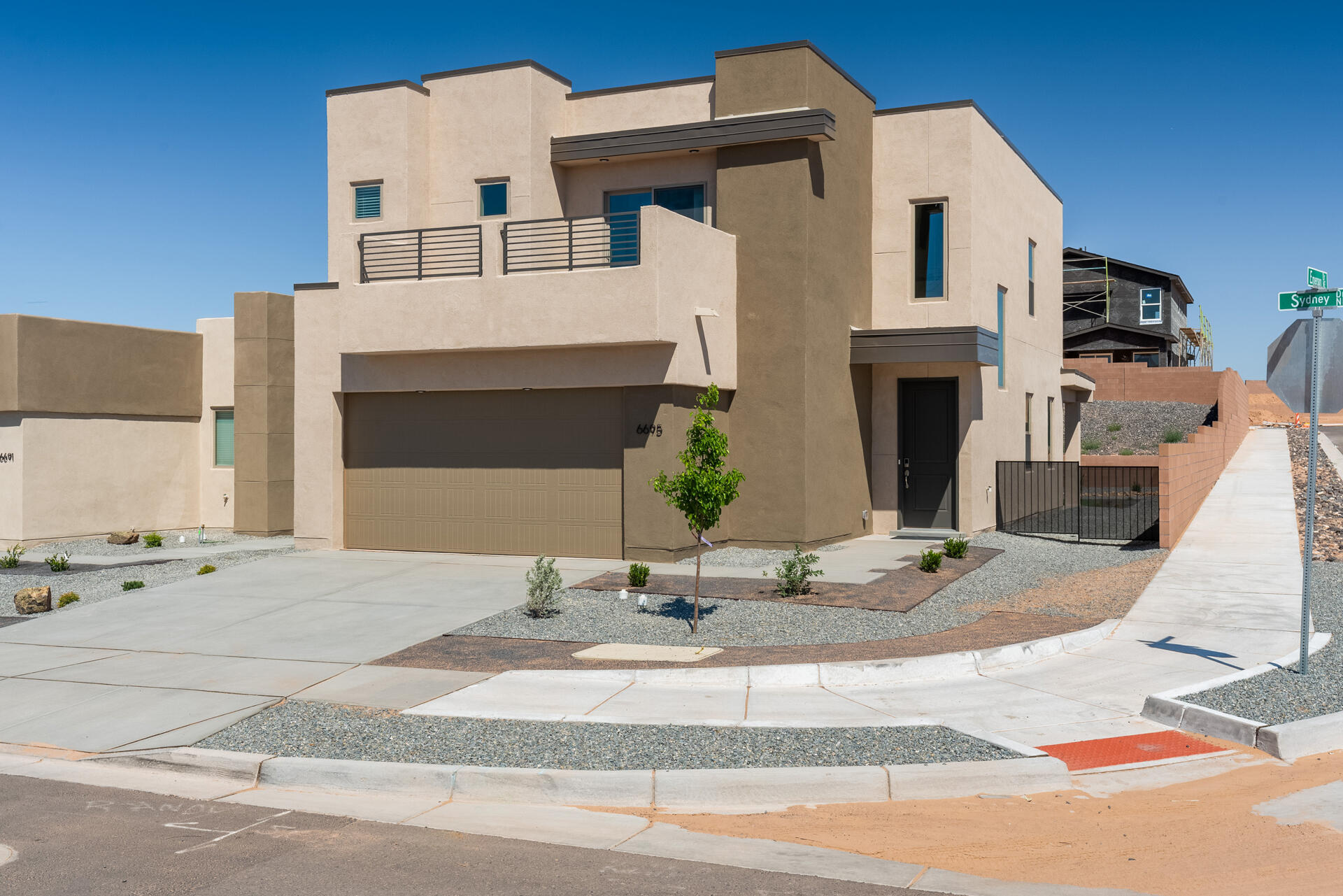 The Loreto plan by Abrazo Homes truly embodies the concept of a ''staycation''. Imagine waking up to the majestic views of the Sandia Mountains right from the comfort of your own front balcony off the owner's suite--it's like living in a permanent postcard. The design of this home focuses on maximizing space with a modern, open layout that blends practicality and comfort. Its sleek, contemporary exterior gives off a refined, modern feel, while the interior provides all the space you need for easy living. On the upper level, you'll find three spacious bedrooms, including the owner's suite with its stunning balcony. The convenience of having all beds and the laundry room upstairs adds to the home's functionality, situated on a corner lot with a finished backyard provides plenty of  enjoyment.