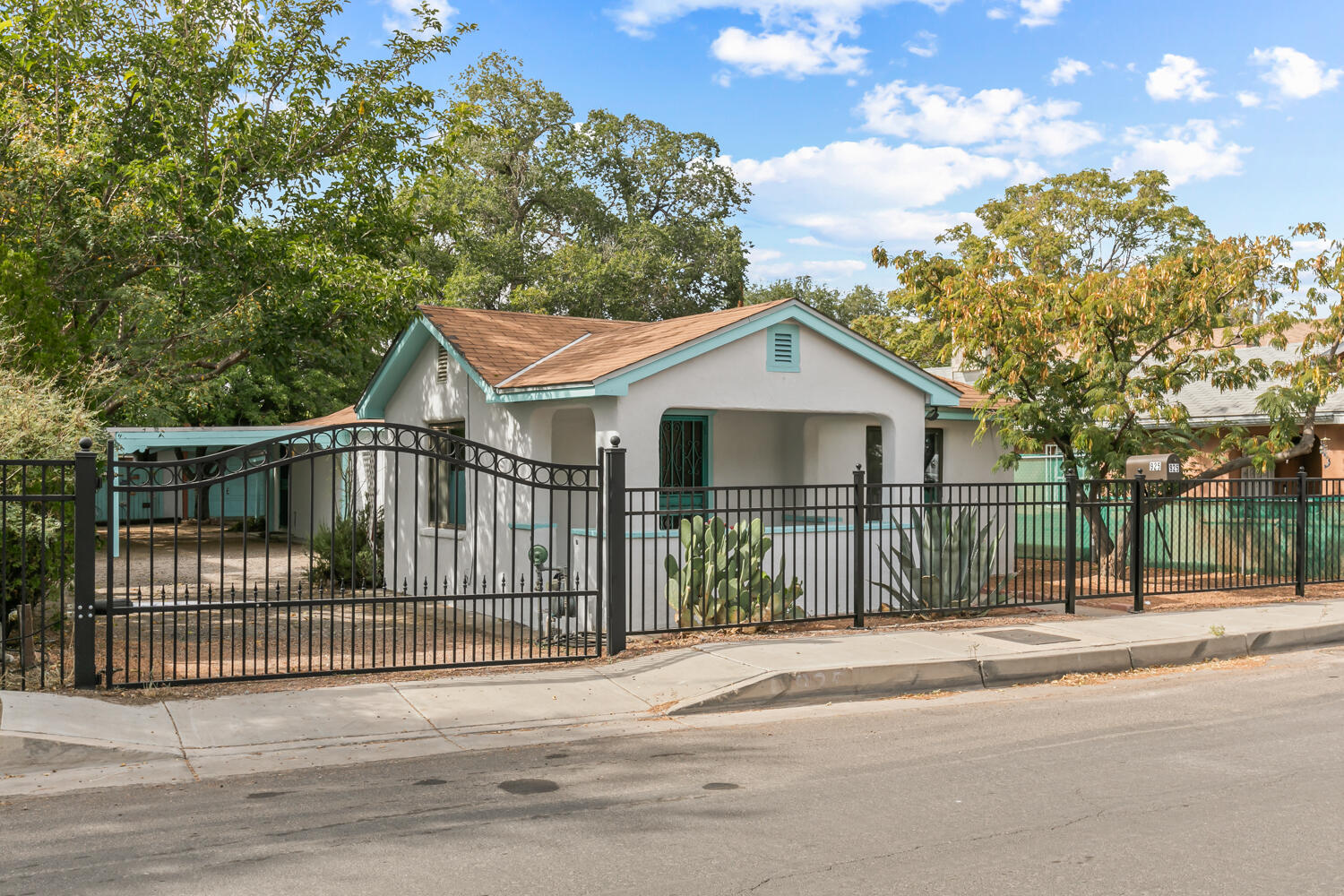 Charming historic Barelas home featuring hardwood floors, cove ceilings, and situated on a double lot.  The rear yard offers a large patio/deck  shaded with mimosa, mulberry & chinese pistache trees - Ideal for entertaining!  Other features include: A large garage and attached shed.  Updates include: sewer line, water line, electric service (200 amps), on-demand water heater, electric gate, R-43 insulation in the ceiling, Solar panels = little to no electric bill!.  Great location situated close to Downtown ABQ.  Walk to the Rail-yard markets, zoo, growers market, numerous coffee shops, art galleries & brew pubs. Great opportunity to experience the best Albuquerque living has to offer!