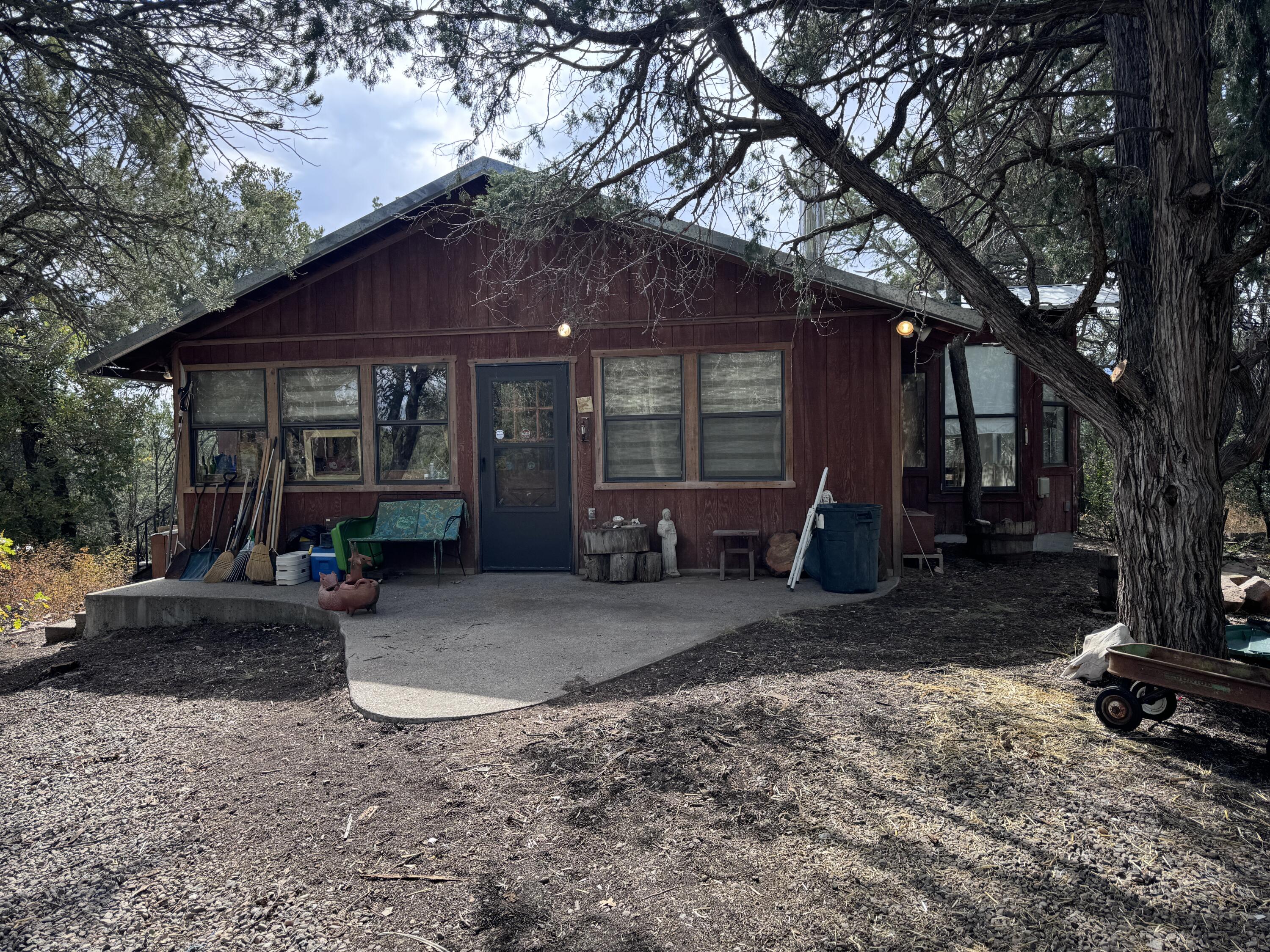 1950's era cabin on 1.5 + acres. Wooded lot located off the Crest road in Sandia Park. Rock faced fireplace for those cold winter nights! Don't miss this unique, one of a kind opportunity!