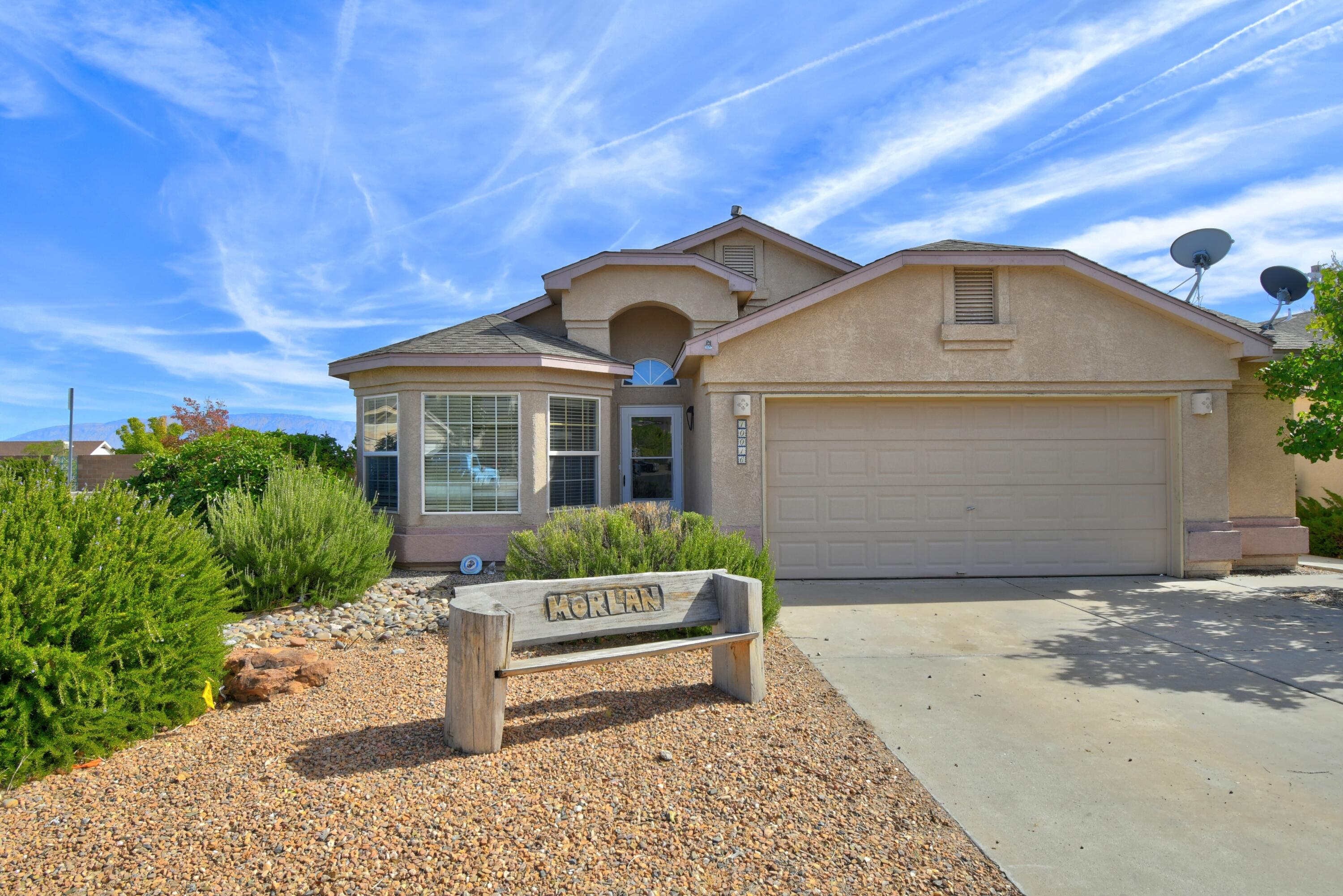 Perfect single story home on a corner lot with mountain views!!  This home features two living areas, one with a fireplace open to the kitchen, three bedrooms and a large yard overlooking the Sandia Mountains.  Refrigerated air, water softener, and tankless water heater have all been put in the last two years!  This home has it all!