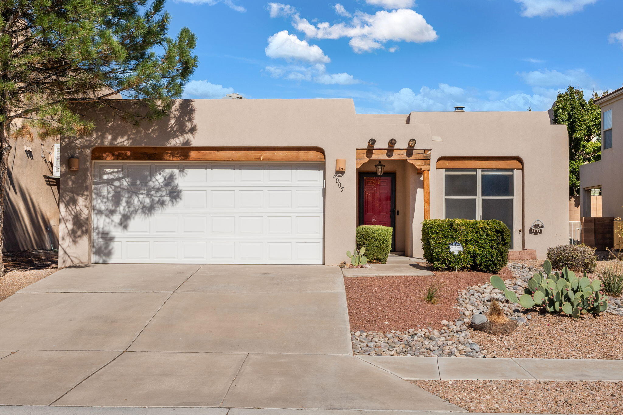 Perfectly located at the city limits of Rio Rancho and Albuquerque! Just minutes from Intel. 4005 Willowbrook welcomes you with 1635 sqft of beautiful new blonde vinyl flooring, raised ceilings with stunning tongue and groove vigas, natural lighting, a remodeled open kitchen and a custom kiva fireplace! With low maintenance landscaping in the front and back, this home is ready for its new owner!