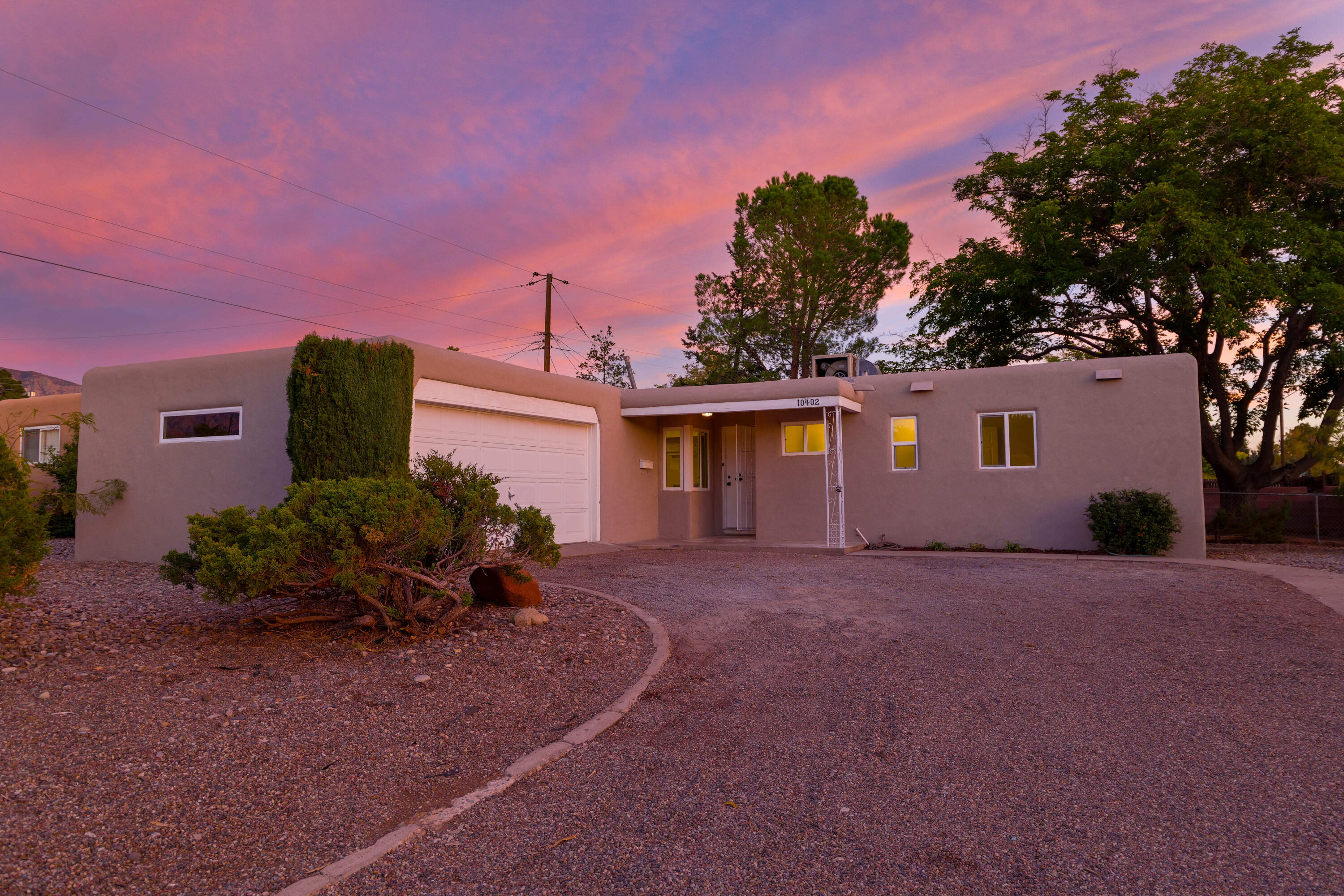 Open House Sunday Nov 3rd. 1-3pm Welcome to this beautifully remodeled home with charming property features on a huge corner lot!!! A bright and spacious living room with a sleek black tiled fireplace, creating a modern and cozy ambiance continuing to the dining area making it perfect for hosting with an elegant setting, enhanced by natural light pouring in from the sliding glass doors that lead to the backyard. The kitchen and bathroom have been tastefully renovated, boasting updated fixtures, a clean white color scheme, and modern hardware, providing both style and functionality. The bedrooms offer a contemporary feel and the Primary bathroom with its tile accents and modern vanity. Spacious backyard, ideal for enjoying New Mexico's beautiful sunsets.