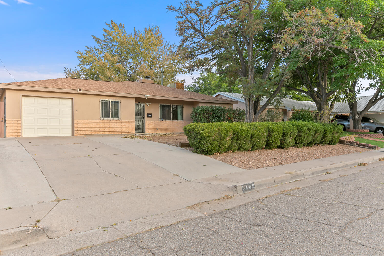 Wonderful NE heights home featuring extensive updates throughout.  Great floorplan offers  large kitchen/dining/living area with fireplace. Updated windows, stucco, remodeled baths/kitchen, finished garage.  Additional 244 SF shop/storage building in back.  Backyard offers views of the Sandias, water feature, large covered patio.  Great location just minutes to I-40!