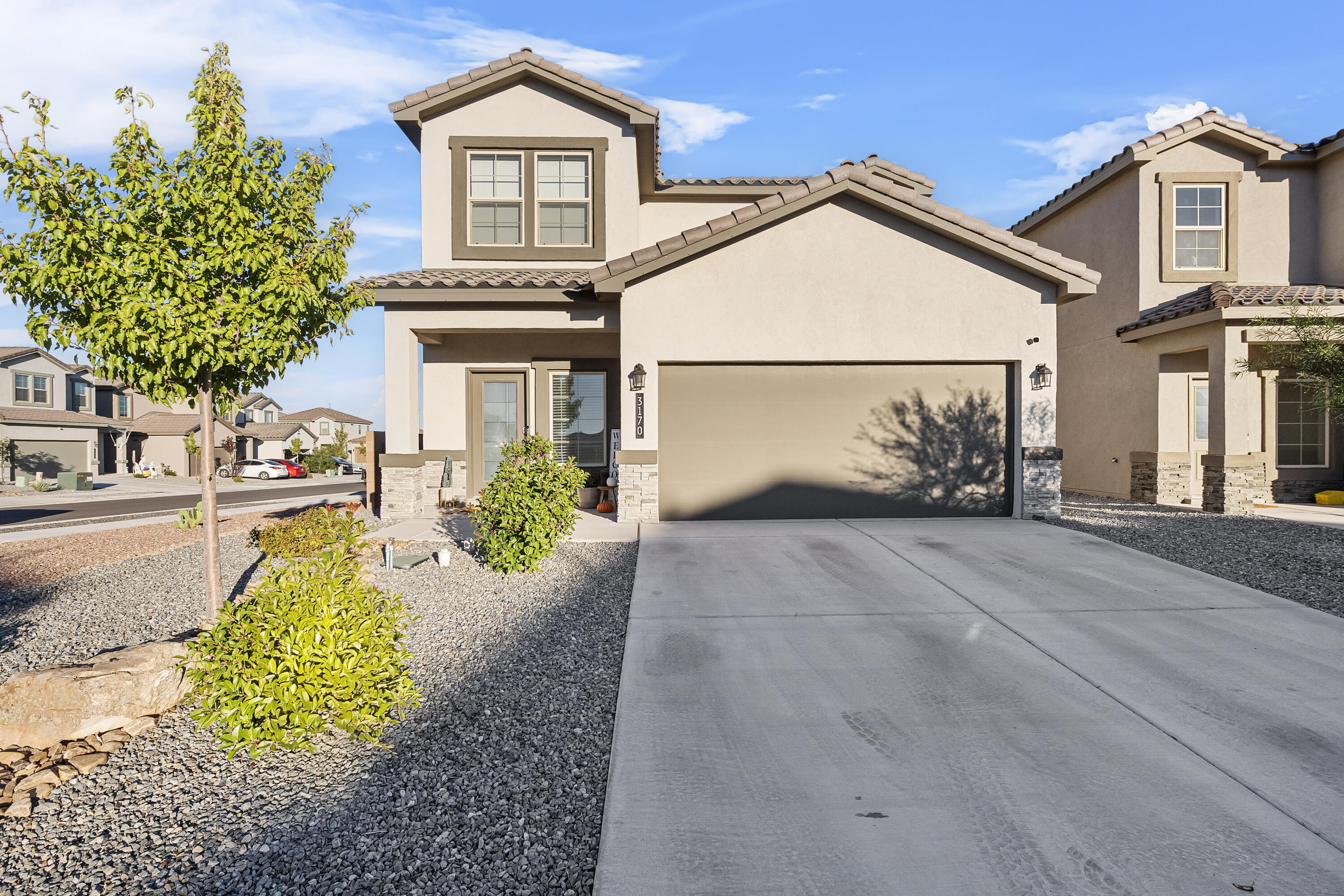 This beautiful home is situated on a fully landscaped corner lot. Inside you'll find an open floor plan that connects the kitchen, dining area, and living room making it perfect for family gatherings. There is also a half bath for guests, and laundry room with washer and dryer included. The kitchen is fully equipped with all appliances. The primary suite is downstairs with a large closet. Upstairs, there is a den, along with three bedrooms, and another full bath. The backyard is fully landscaped with extended patio flooring that is followed by artificial turf with a view of the Sandia Mountains.