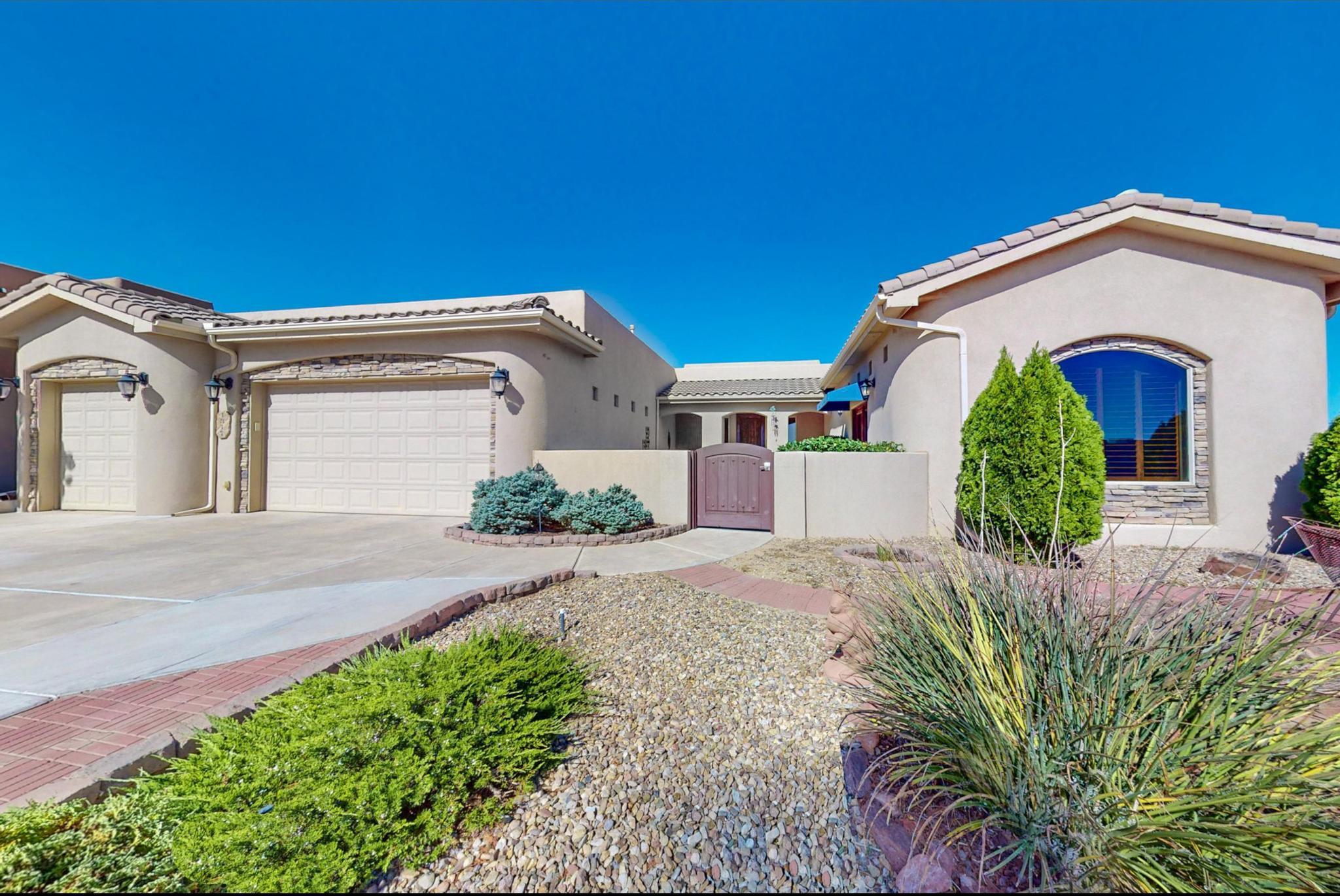 Situated on a spacious 1/2 acre lot in Rio Rancho near Rust Hospital, this stunning home boasts tall ceilings, custom skylights flooding the space with natural light, and upgraded tinted windows offering panoramic views of city lights and mountains. The property features a fully equipped game room/bonus/flex room/bedroom, walk-in closets in two bedrooms, quality wood doors and cabinets, slow-closing drawers in the kitchen, pot filler, Wolf microwave, double oven & an induction cooktop, a walk-in pantry, and two charming fountains. The backyard is perfect for entertaining with room for a pool, built-in grill, and pizza oven, your very own outside kitchen. The kitchen, primary bathroom, and outdoor cooking area all showcase elegant granite countertops.