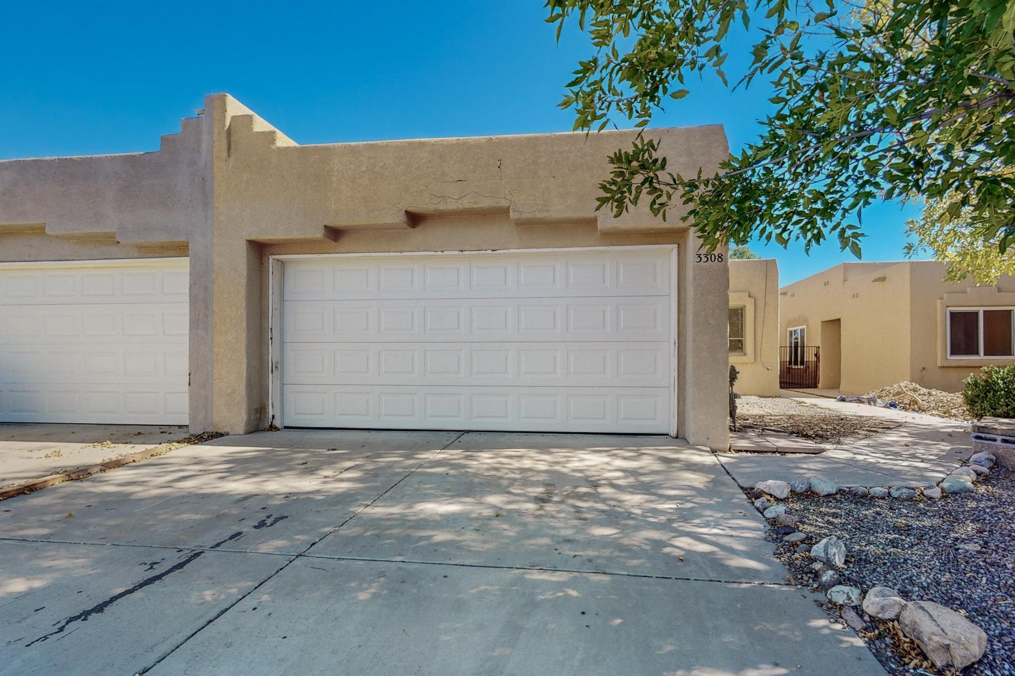 This 3-bed 2-bath townhome in Ladera West is light, bright & move-in ready with vaulted ceilings, oversized windows & outdoor space. Low-maintenance landscaped lot with attached 2-car garage. Partially open floor plan allowing maximum natural light throughout. Entry opens to cozy living room with central fireplace, connecting to dining area & kitchen complete with appliances, built-in cabinet & breakfast nook with French doors to backyard patio. Primary with ensuite & additional bedrooms boasting ample space with sizable closets. Located near neighborhood parks, steps from Ladera Golf Course, situated along the edge of Petroglyph National Monument with views looking up to JA Volcano -- outdoor activities are ENDLESS in this area known for its wide open spaces & hiking trails!