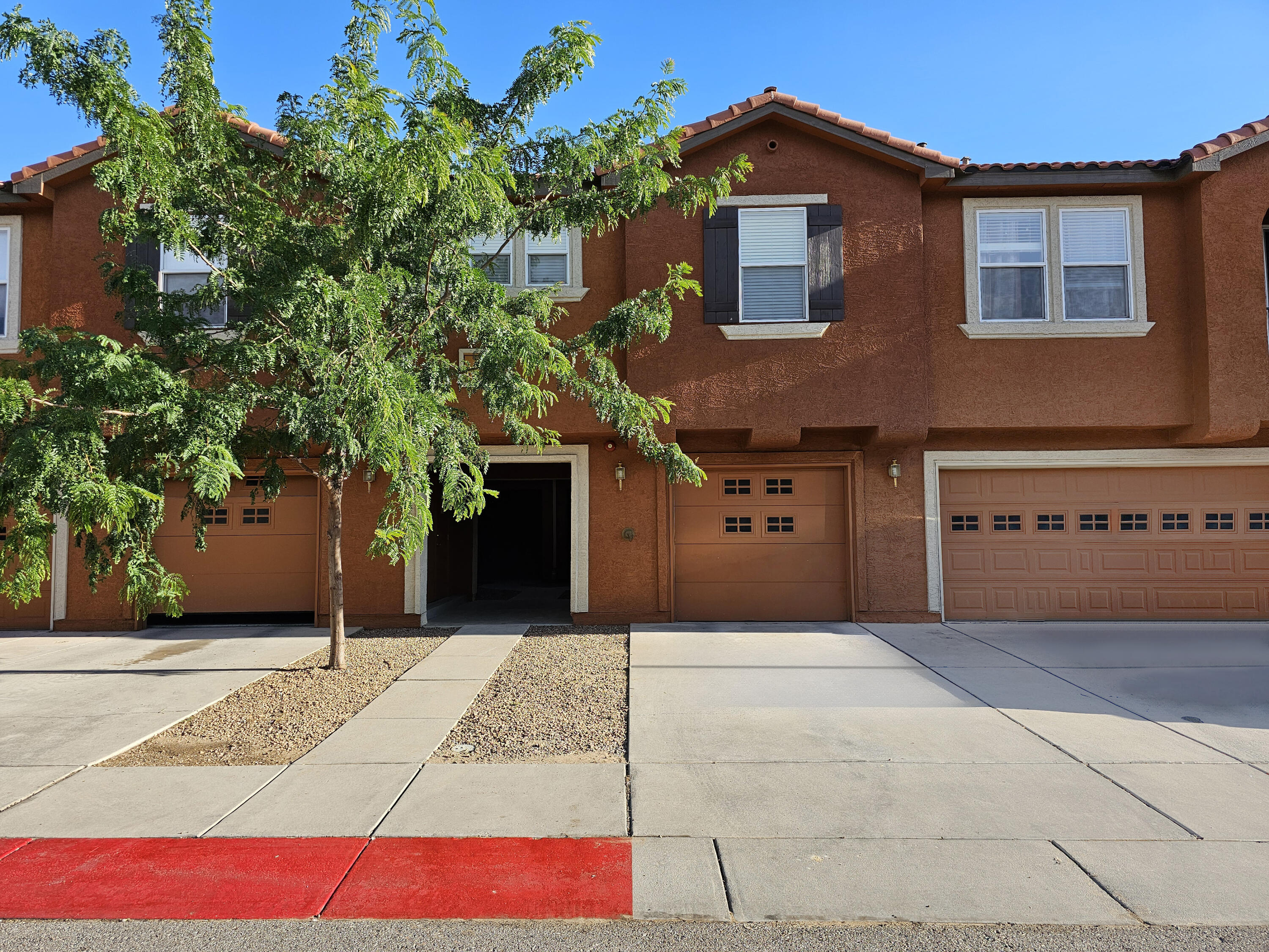 Welcome home to this beautifully maintained two-story condo. The bottom level features a modern kitchen, a spacious living room, a half bath, a dining area, and a convenient laundry room. Upstairs, you will be greeted by three comfortable bedrooms, including the primary bedroom, which boasts a walk-in closet and a bathroom with a double vanity. This condo is conveniently located near UNM and CNM, providing easy access to education, leisure, and entertainment. Enjoy the perfect blend of comfort and convenience in this lovely home.