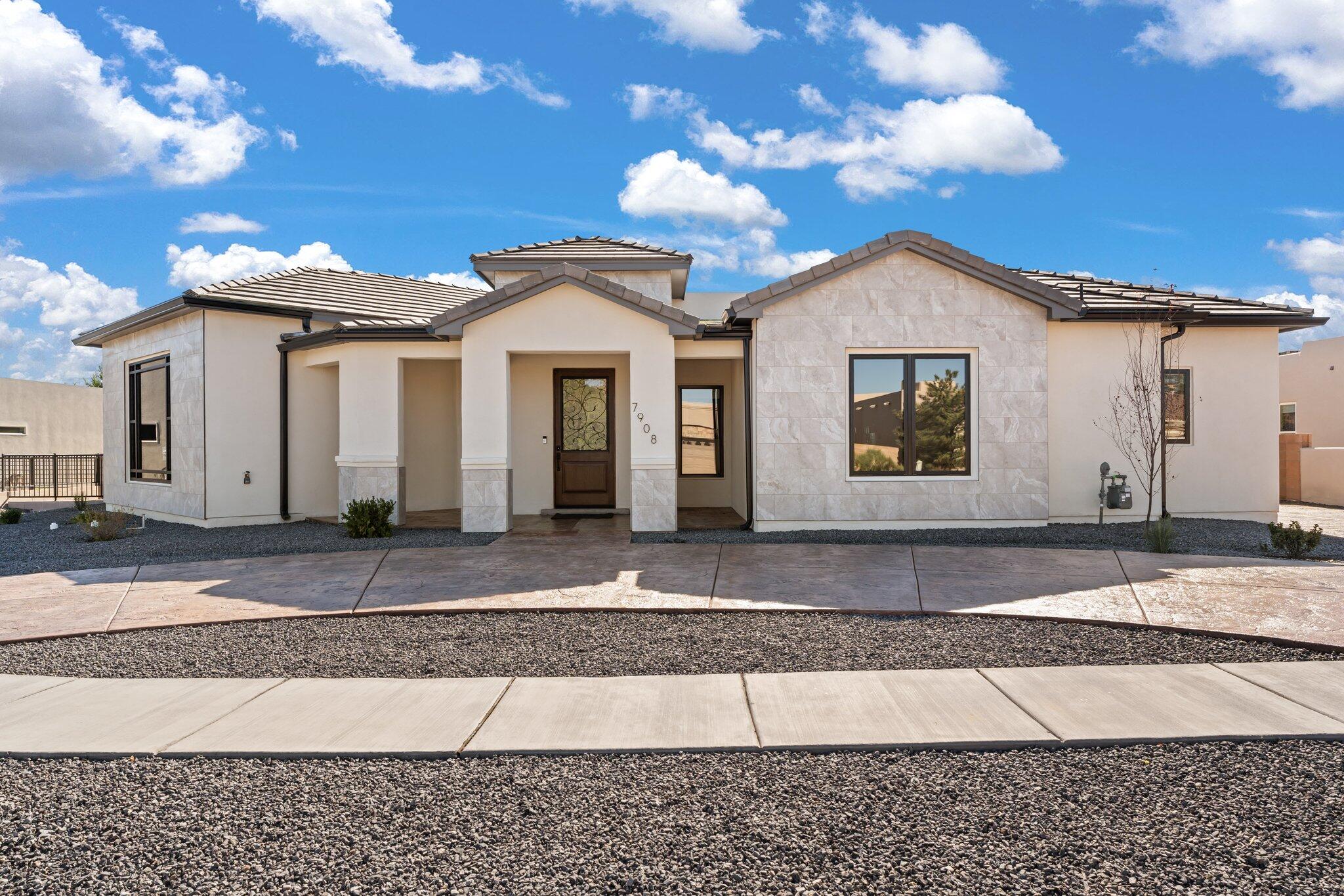 Exquisite custom built single story complete with top tier amenities and modern conveniences! Home features 3,082sf with 4 bedrooms, 3.5 bathrooms and a 3 car garage!  Expansive family room with a custom modern fireplace, built-in cabinets and a picture window showcasing those stunning Sandia views! Stunning kitchen with light oak cabinetry, quartz countertops, built-in gas oven/microwave, gas cooktop, custom range, wine fridge, refrigerator, large island with seating and custom lighting. Huge butlers pantry with built-in cabs and a sink. Beautiful owners retreat with built-in bookcase, outside access and spa-like bath. Bath with his/hers sinks, dressing area, freestanding tub, walk-in snail shower and walk-in closet. Gated back yard access, huge patio with built-in wet bar!