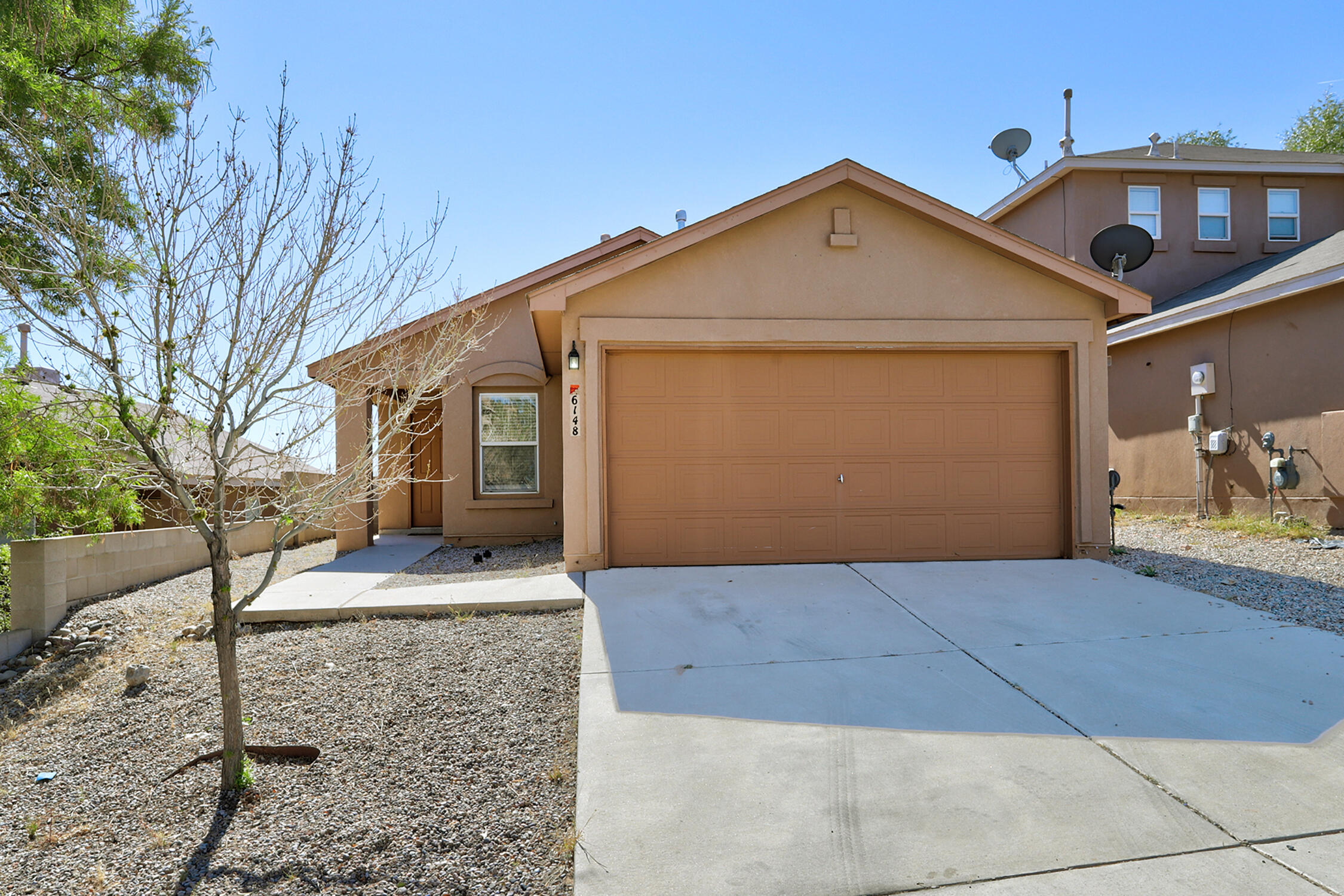 Adorable and affordable! This move-in ready home has a nice floor plan with a large, open living room, dining area, and kitchen! Enjoy your outdoor space with a patio under the shade of a mature tree. NO CARPET, so you'll enjoy easy care flooring throughout. Bright and welcoming! Stay engaged with loved ones and friends with the large opening between the kitchen and living room. Spacious kitchen has plenty of room fora table and easy access to the patio. Primary suite has a private full bathroom and walk-in closet. 2 additional bedrooms & full hallway bathroom. Greatlaundry/mud room off the 2 car garage, too! Seller is doing some light rehab on the property.