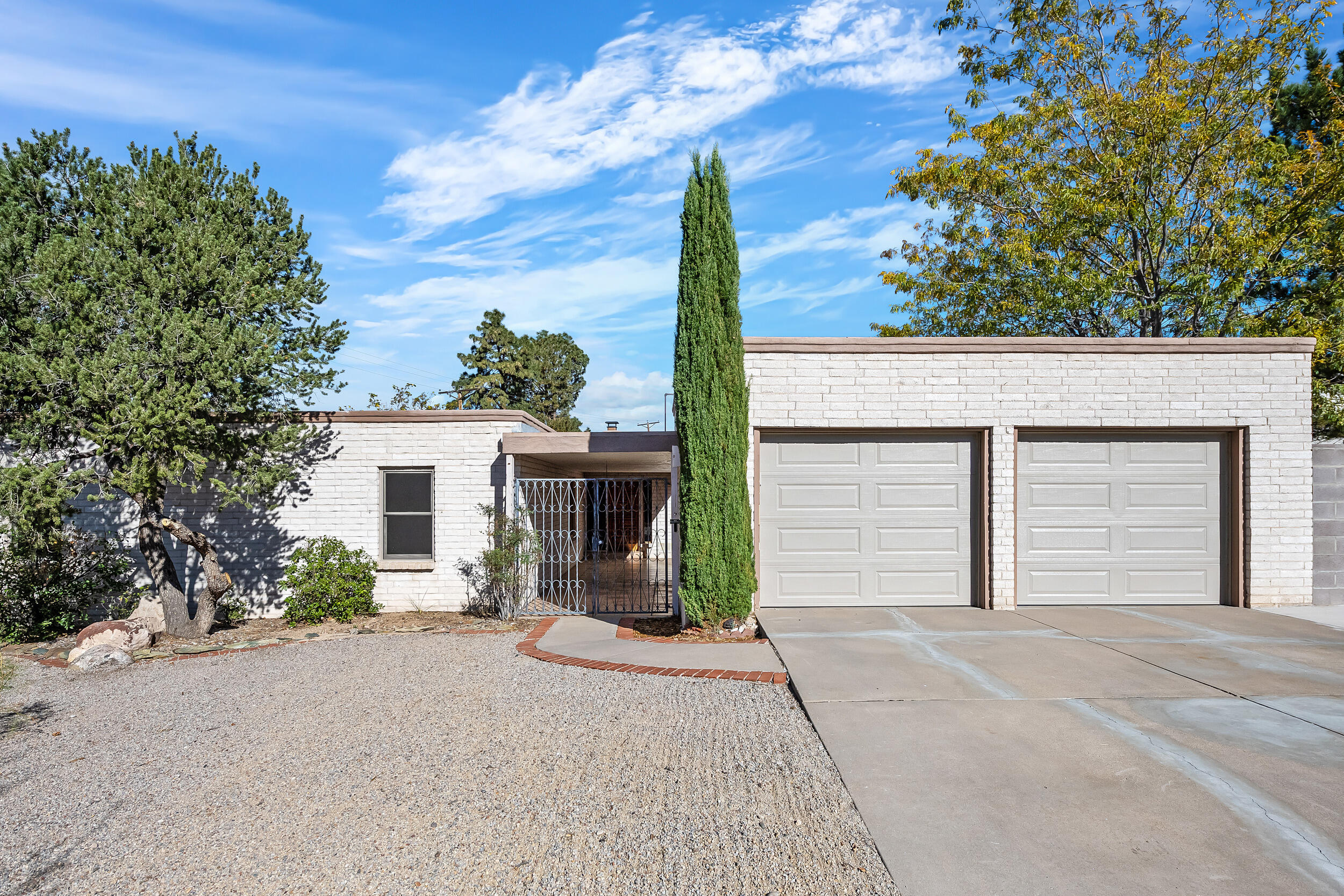 Come home to a very special, spacious home just waiting for a new family. Plenty of room for entertaining, hobbies, outdoor adventure and enjoying life. The kitchen has a pantry, ample granite counterspace and opens to the outdoor expansive covered patio. There is kitchen eating space and a formal dining room with tongue-in-groove ceilings. A spectacular stone fireplace warms the generous family room. There is room to spare with four bedrooms, two living areas and two large outdoor areas. The oversized double garage opens to a spacious courtyard leading to the front entry, all secured by an impressive locked gate. The verdant outdoor grassy area includes raised flower beds, a hot tub & storage shed. This home has been filled with love over many years and now you can continue this legacy.