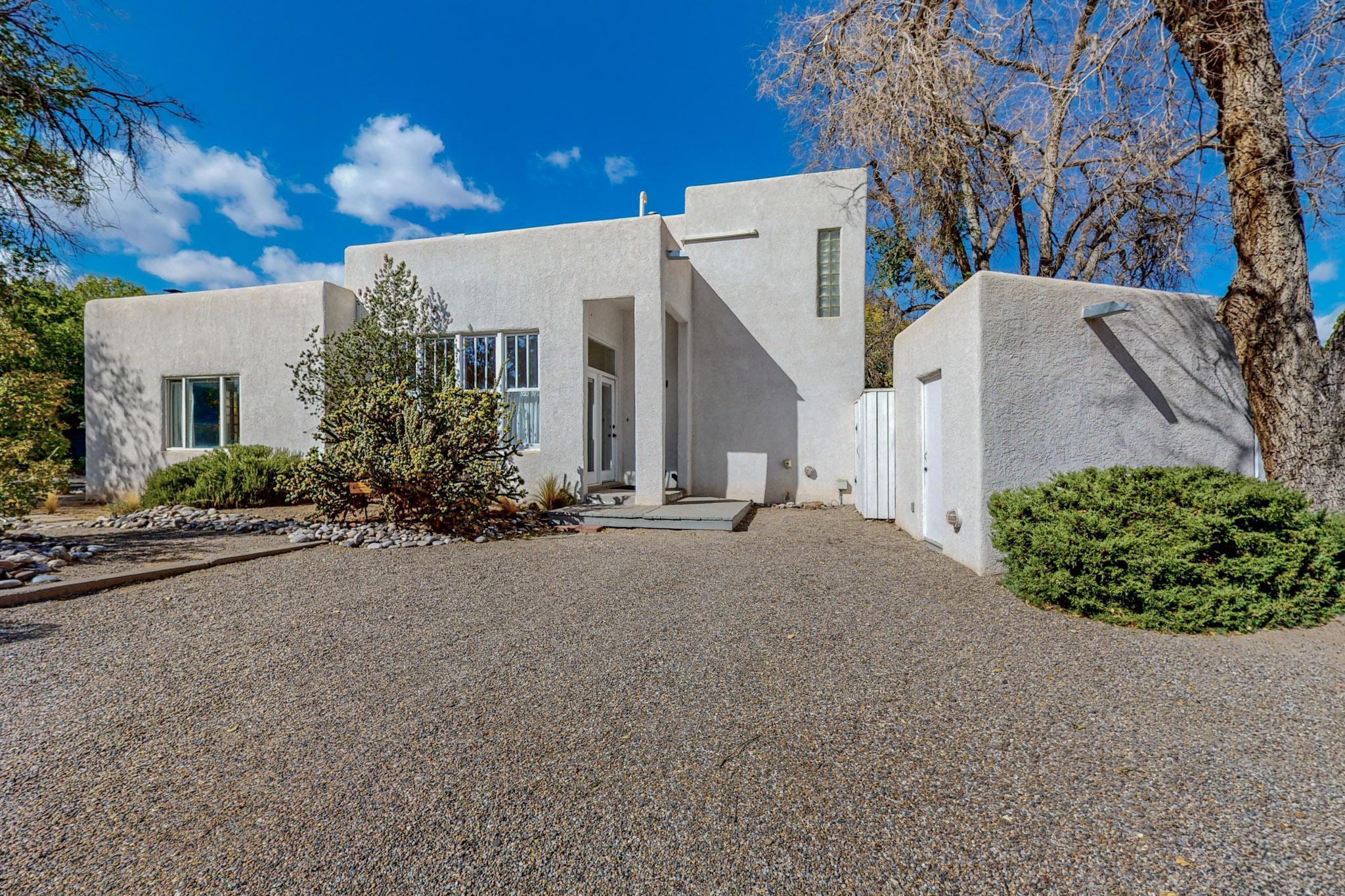 Close to Nob Hill, this 4-bedroom 3-bathroom property is sure to charm.  Enjoy the traditional living & dining room plus the spacious family room that opens to an outdoor patio making the home & yard one. Features wood and tile floors, cove ceilings in living/dining areas, and glass brick accents. The landscape in front was professionally designed and is mature, lush,  and xeric. Mountain Views off the upstairs patio! 2 Private Courtyards W/ Large Deck for shady relaxation all day. Quick access to Hyder Park, Bandelier Elementary, UNM, & historic Nob Hill near restaurants & shops. If you want to be in the center of ABQ with beautiful enjoyable private spaces, you need to visit this home.